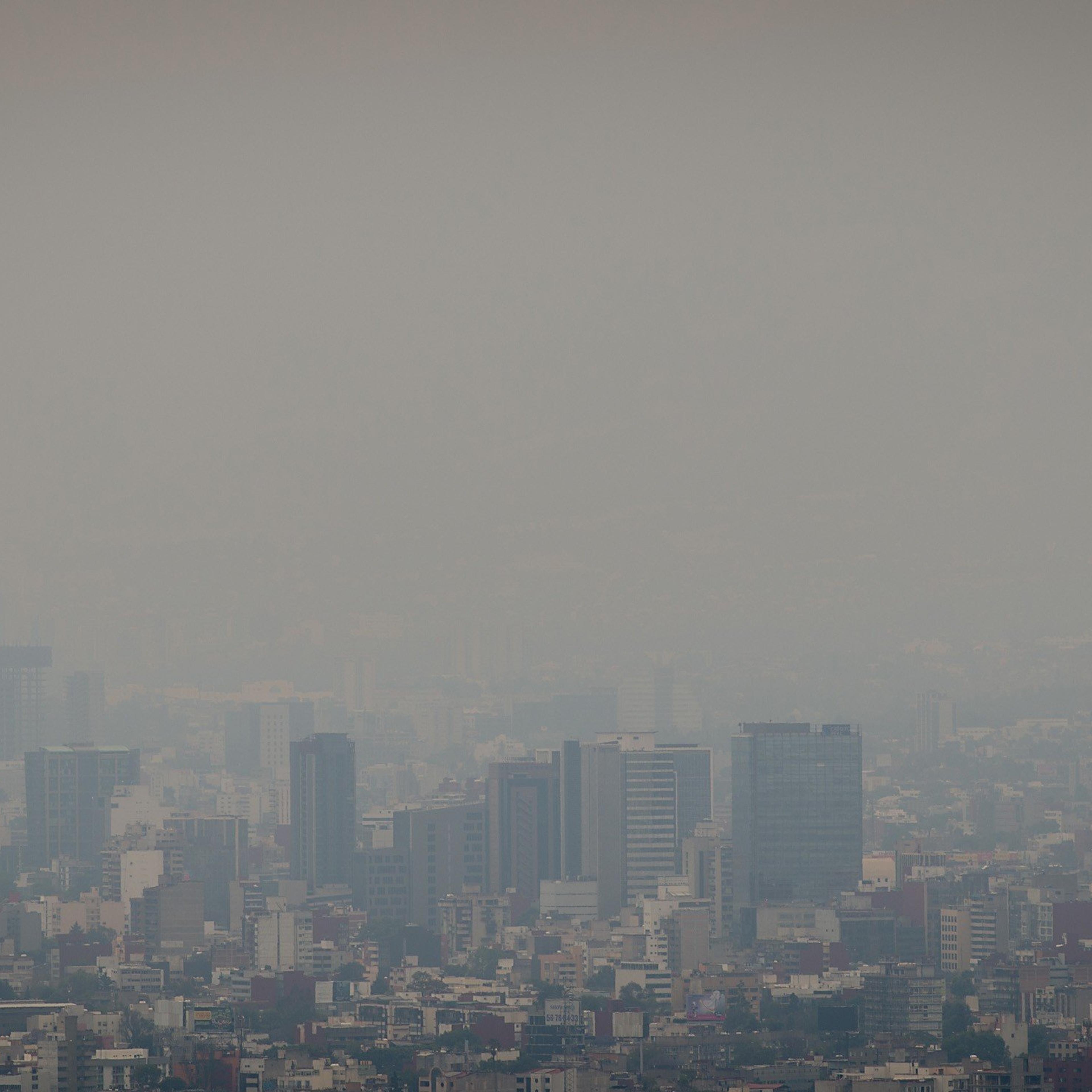 This photo shows a view of the dense smog layer covering the buildings from the look-out of the Torre Latinoamericana, in Mexico city on March 17, 2016.