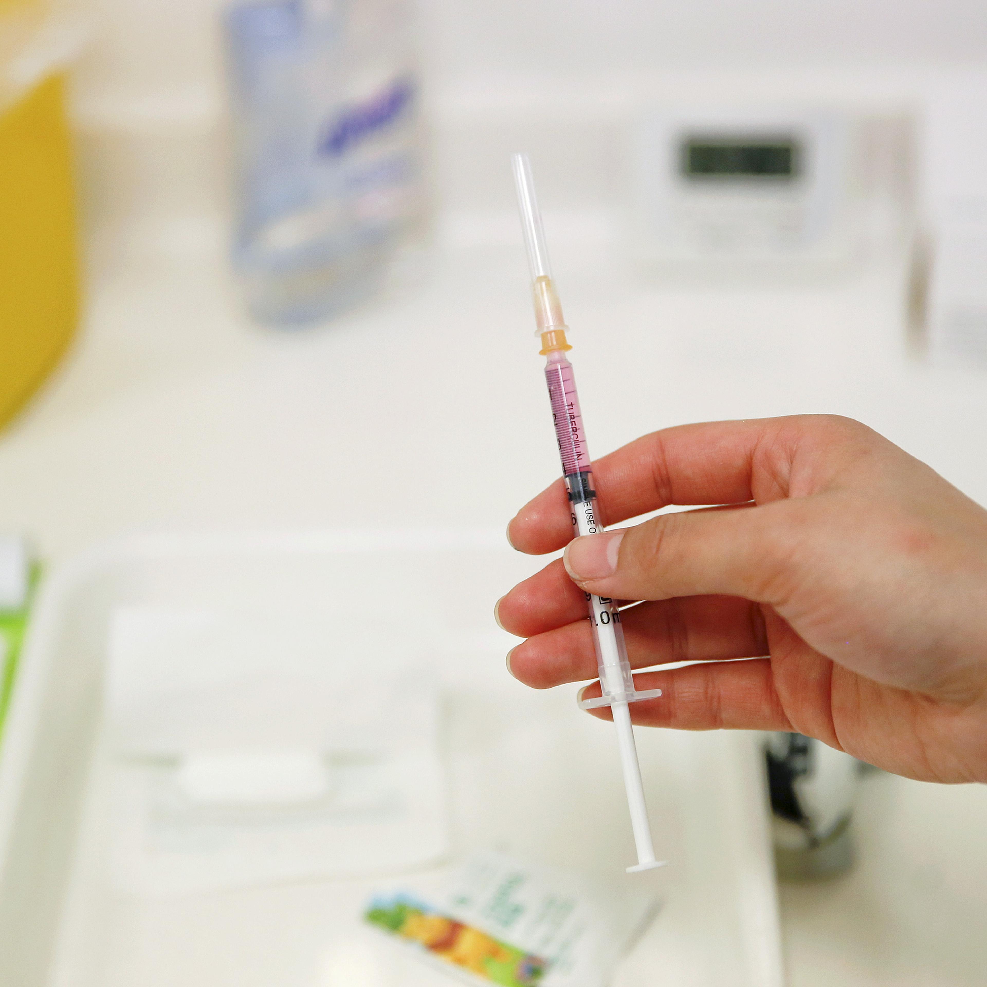 FILE PHOTO: A nurse prepares a vaccine to be given to a child in a hospital in Beijing