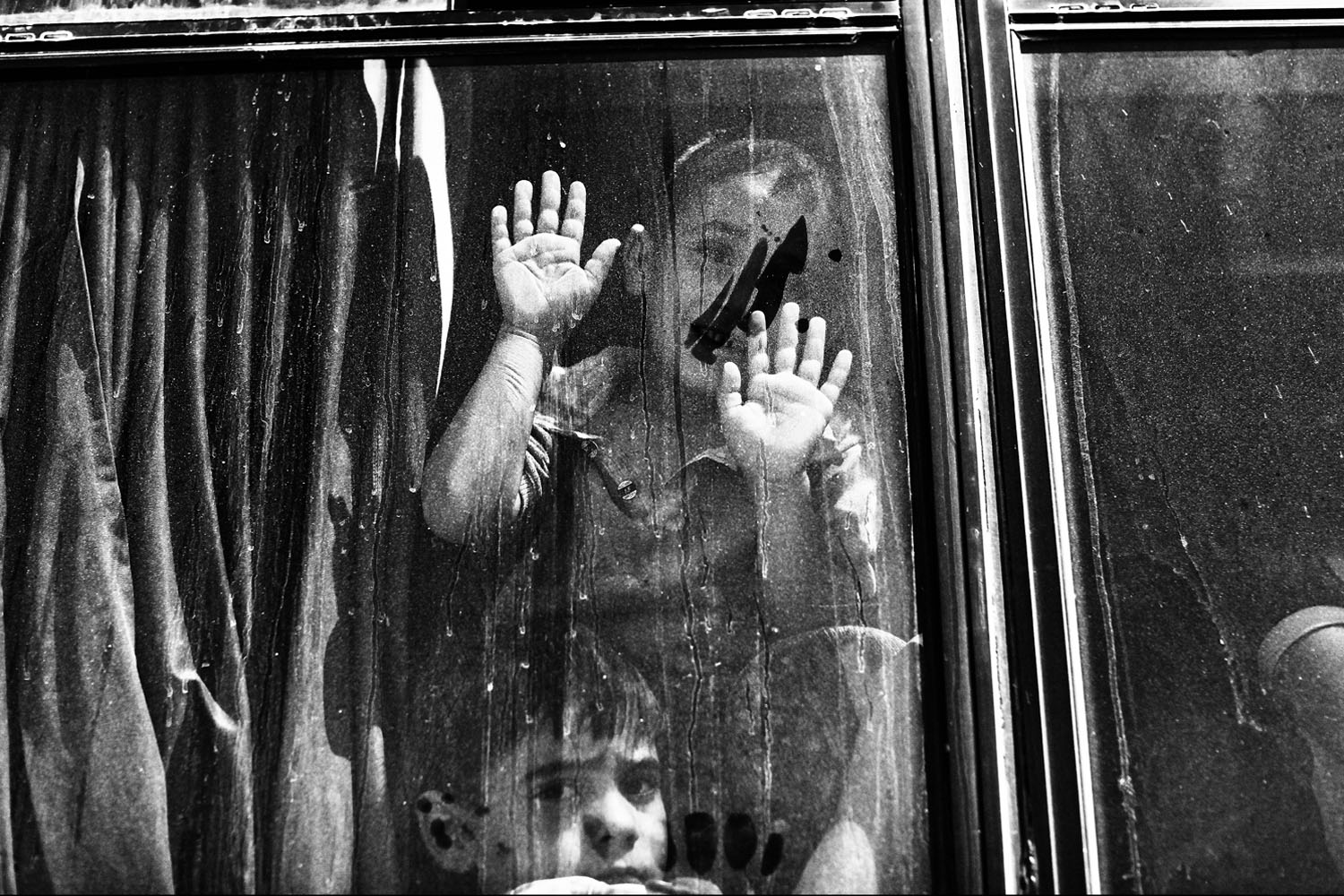 JORDAN. Zaatari. Refugee Camp. September 1, 2012. A Syrian boy waves from aboard a bus heading back to Syria from the Zaatari refugee camp in Jordan. Many families have decided to return to Syria due to the bad living conditions in the Zaatari refugee ca