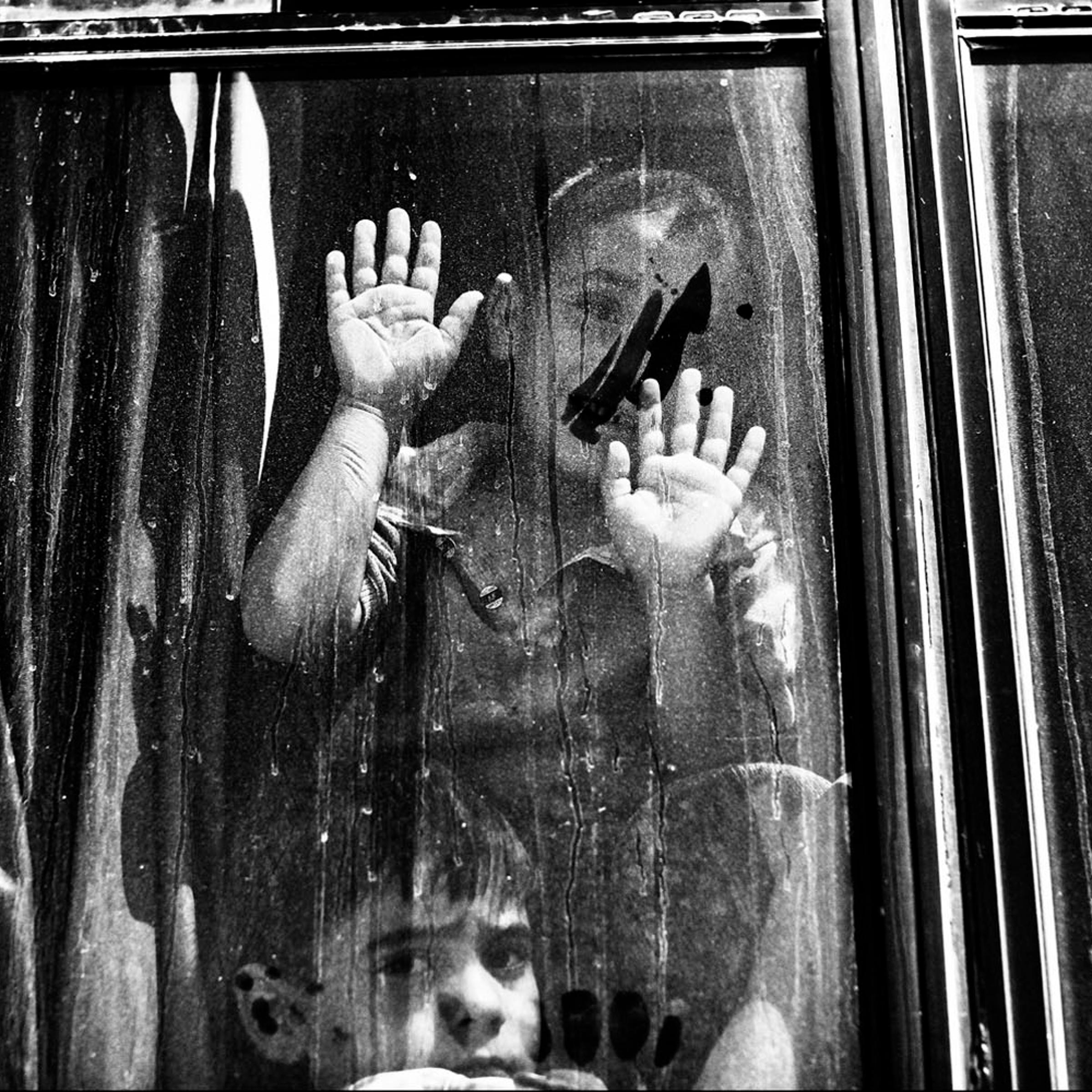 JORDAN. Zaatari. Refugee Camp. September 1, 2012. A Syrian boy waves from aboard a bus heading back to Syria from the Zaatari refugee camp in Jordan. Many families have decided to return to Syria due to the bad living conditions in the Zaatari refugee ca
