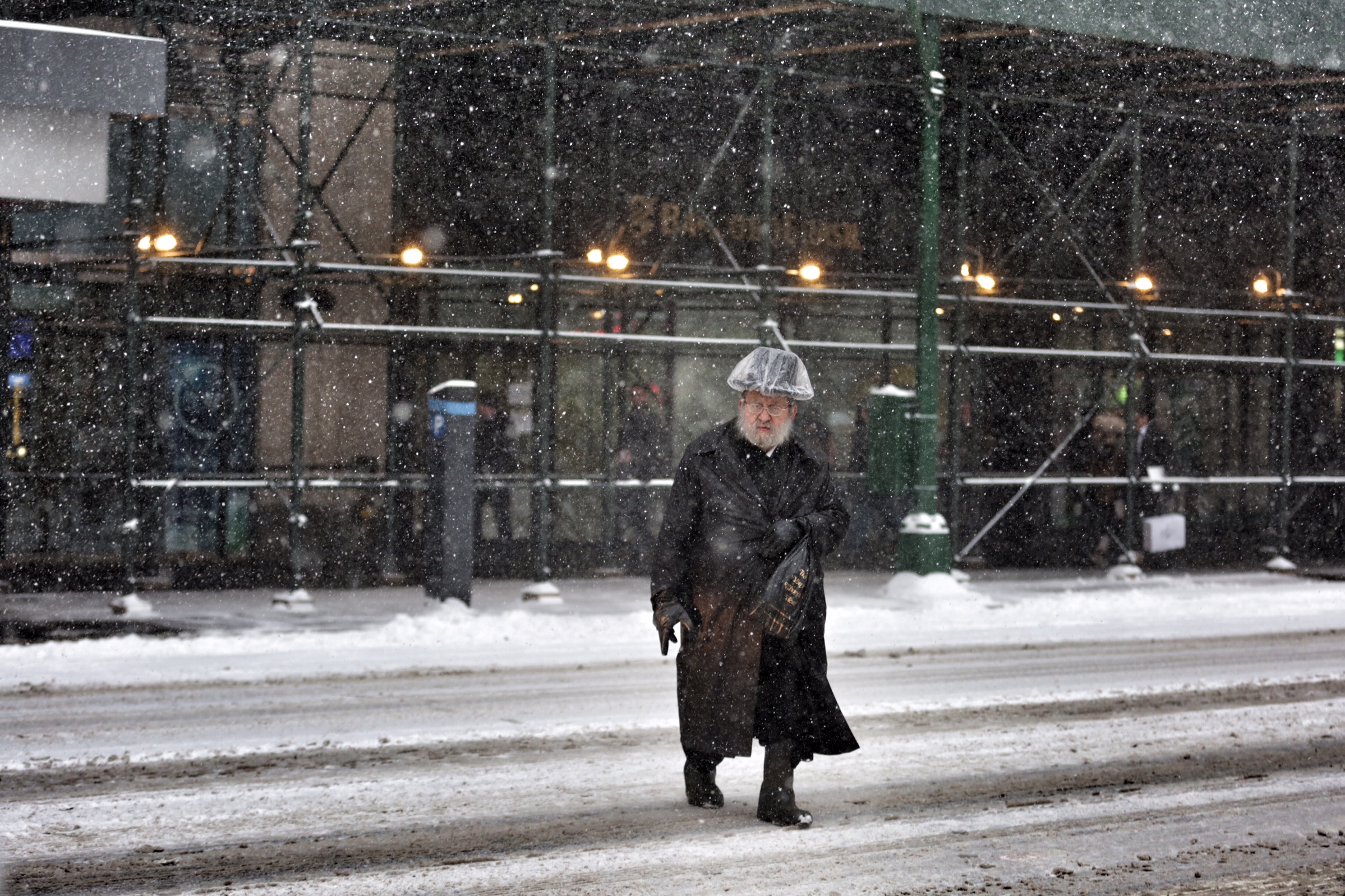 A man crosses the street during a snow storm in New York City on Jan. 26, 2015. 