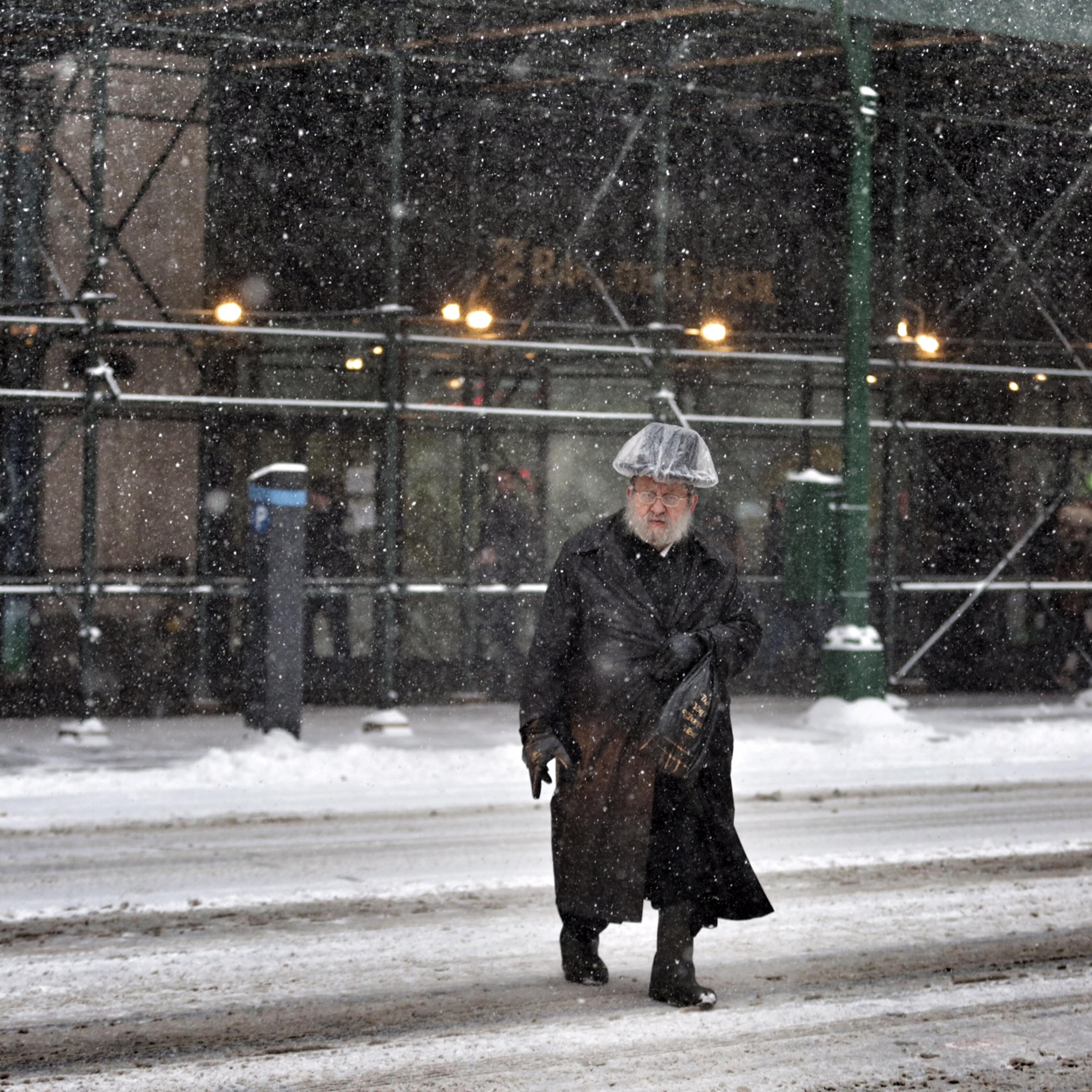 A man crosses the street during a snow storm in New York City on Jan. 26, 2015.