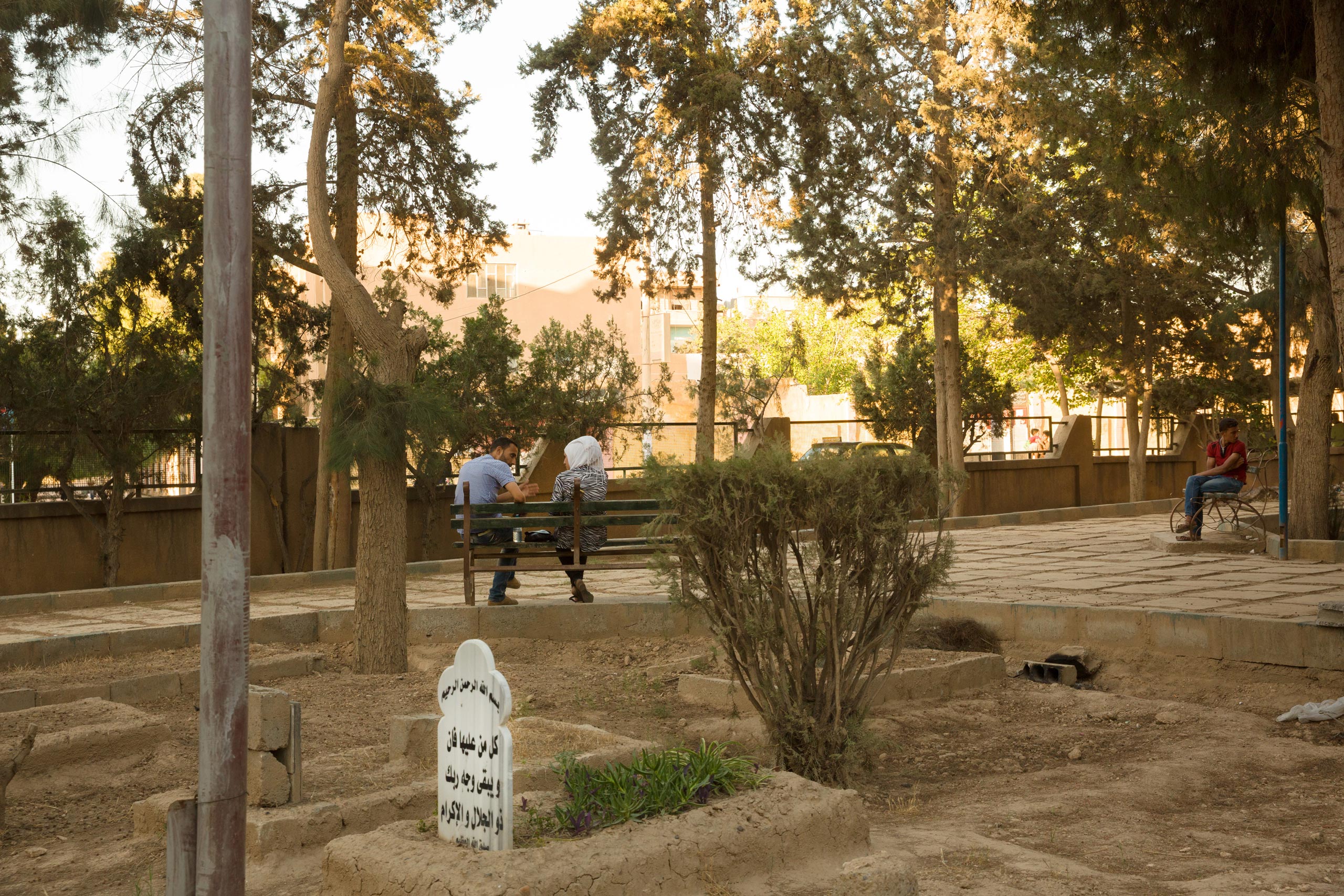 A burial ground in a city park in Deir-ez Zor. Residents have stopped burying their dead in the main cemetery where they fear being targeted by ISIS snipers who surround the city, June 1, 2015.