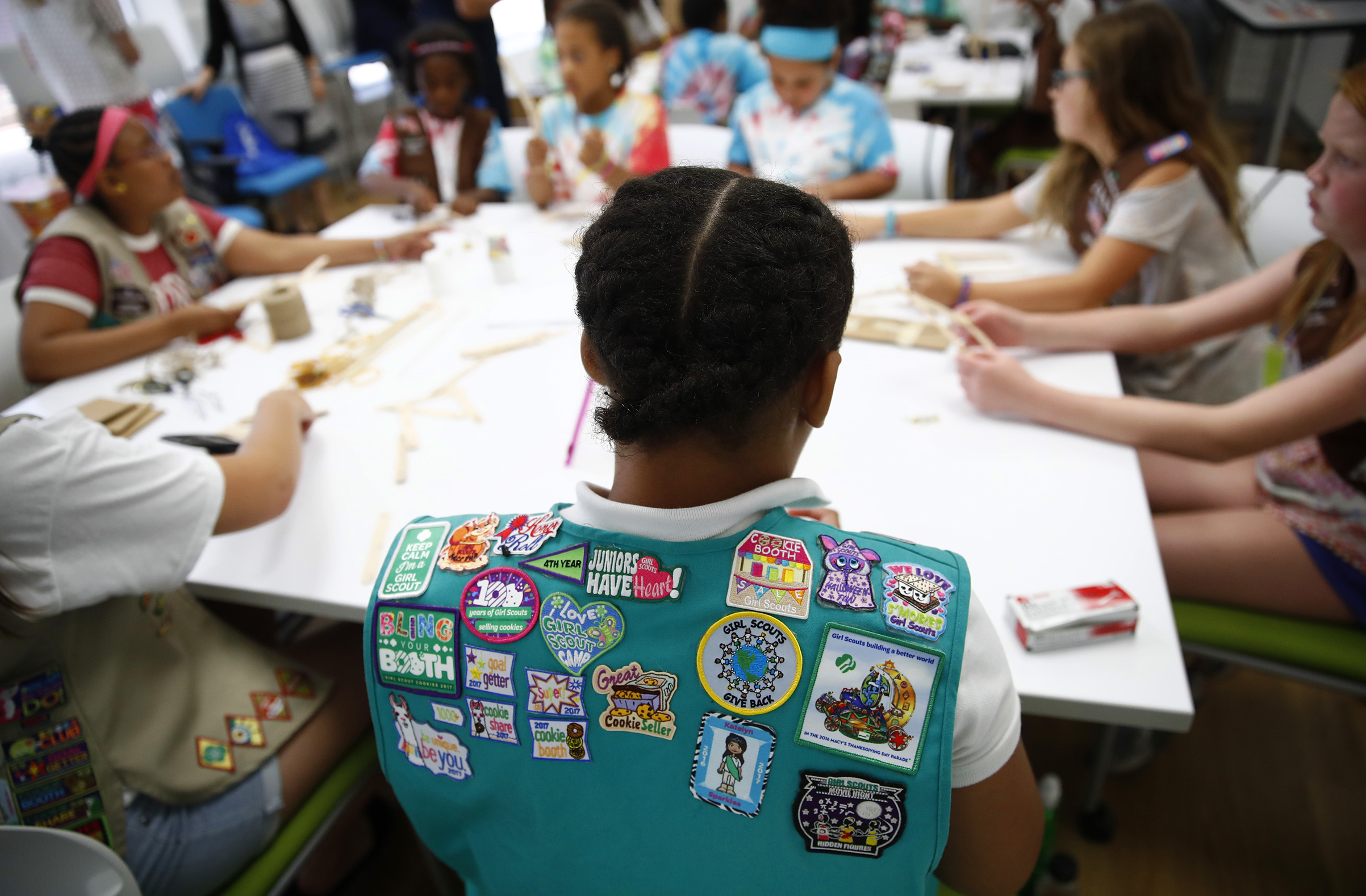 Badges are seen on the vest of a member of the Girl Scouts of Central Maryland as Girl Scouts participate in an activity introducing them to the world of robotics in Owings Mills, Md., July 21, 2017.