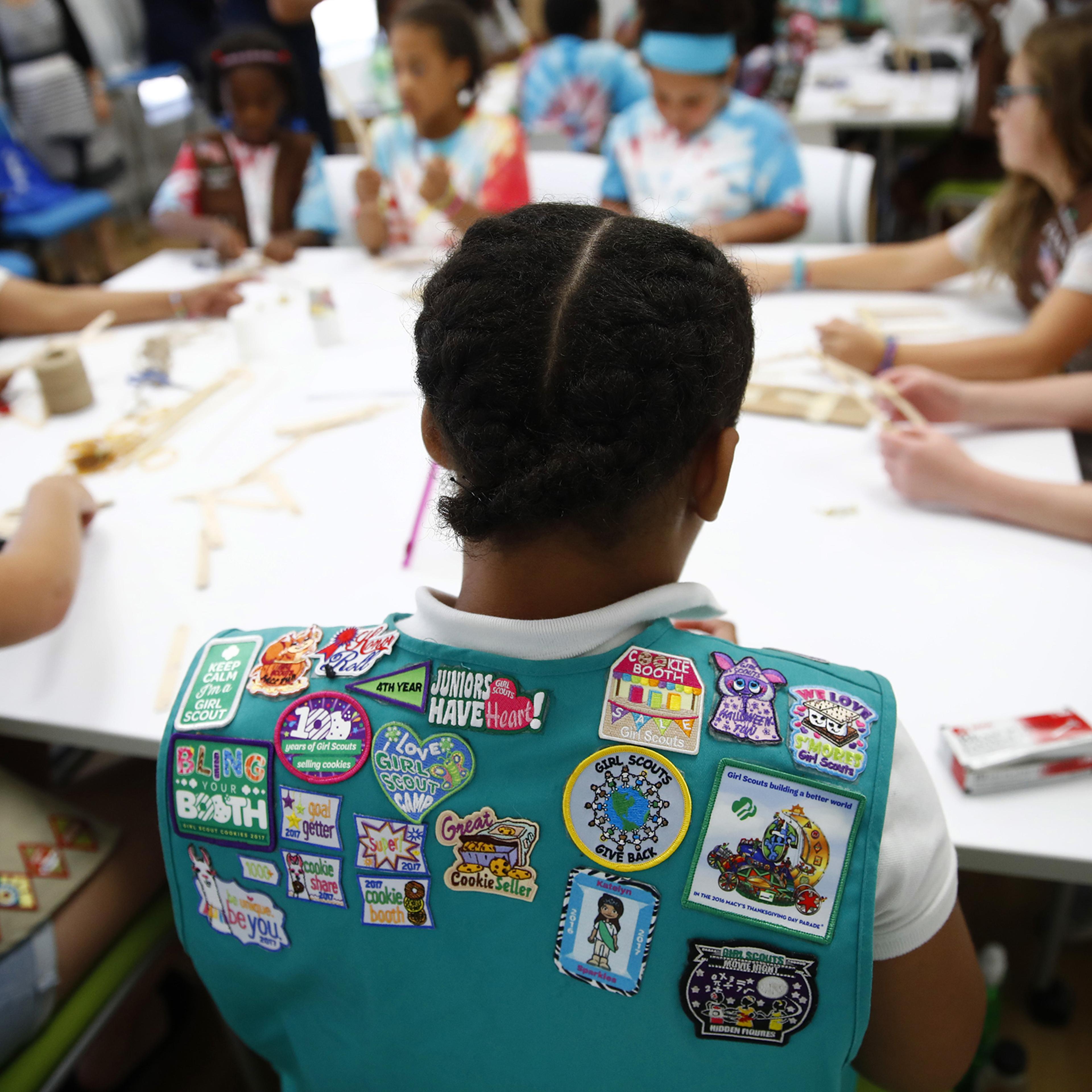 Badges are seen on the vest of a member of the Girl Scouts of Central Maryland as Girl Scouts participate in an activity introducing them to the world of robotics in Owings Mills, Md., July 21, 2017.