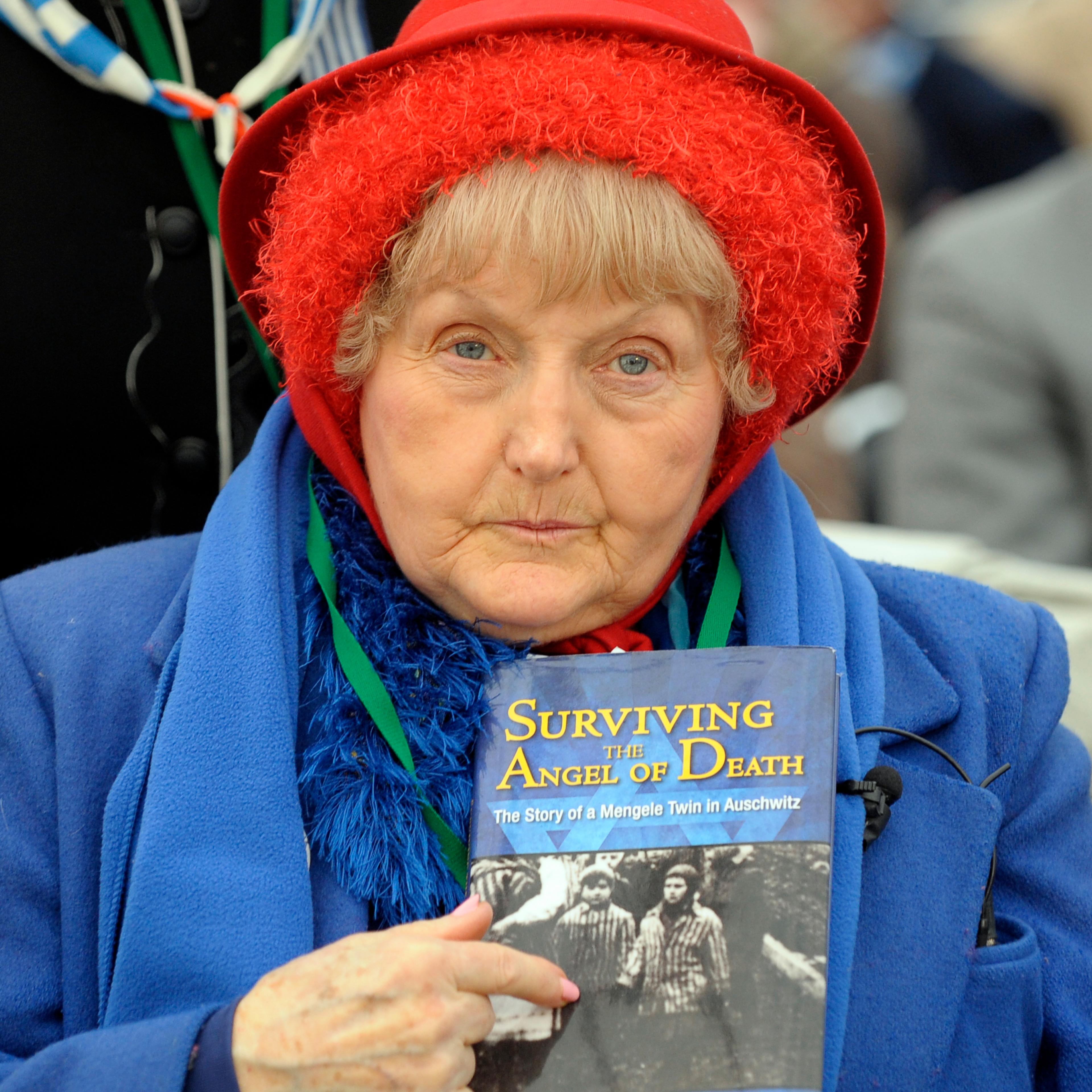 Eva Mozes Kor, a twin who survived pseudo-medical experiments at the Nazi Auschwitz death camp by Dr Josef Mengele points to a wartime picture of her sister Miriam and herself on Jan. 27, 2010.