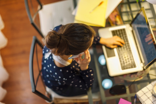 Young woman working with laptop at home
