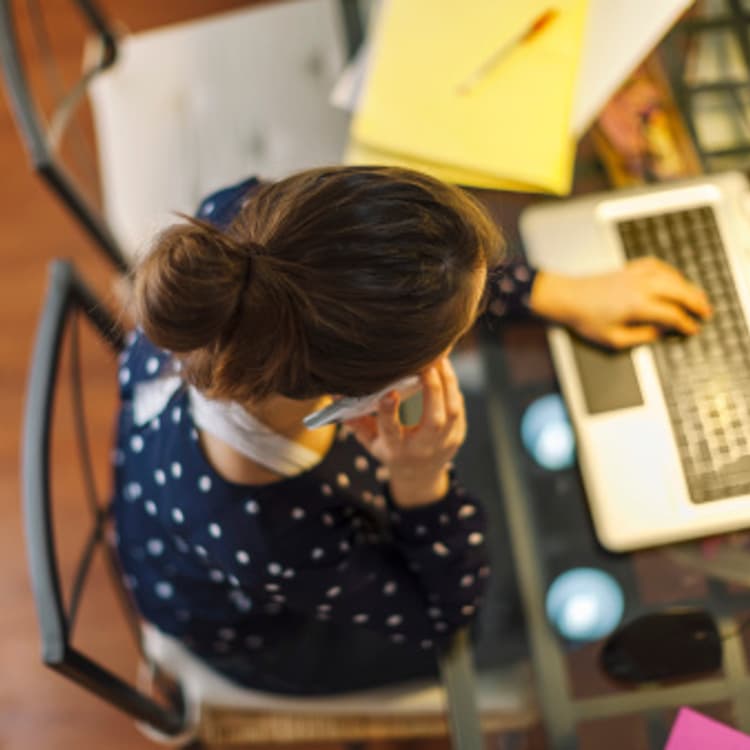 Young woman working with laptop at home