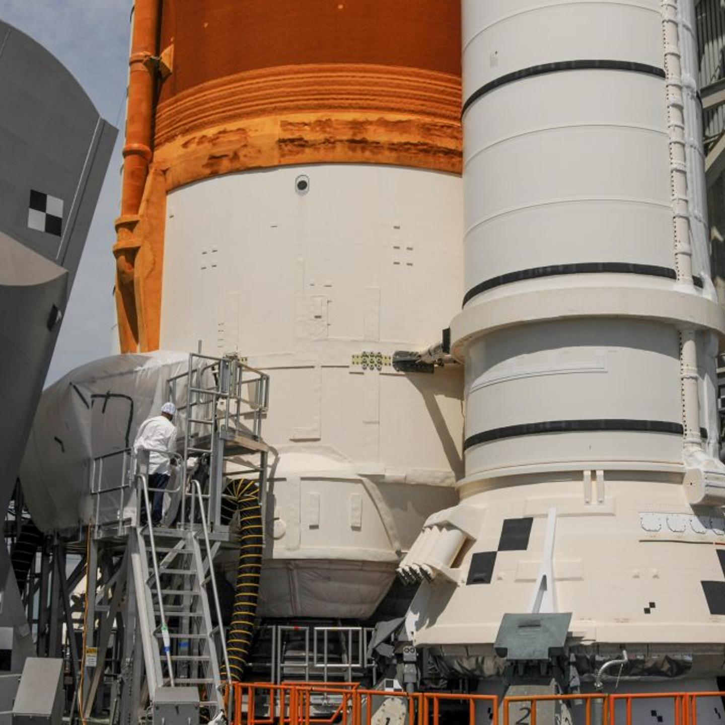 Engineers at work fixing umbilical leaks at the base of the Space Launch System moon rocket