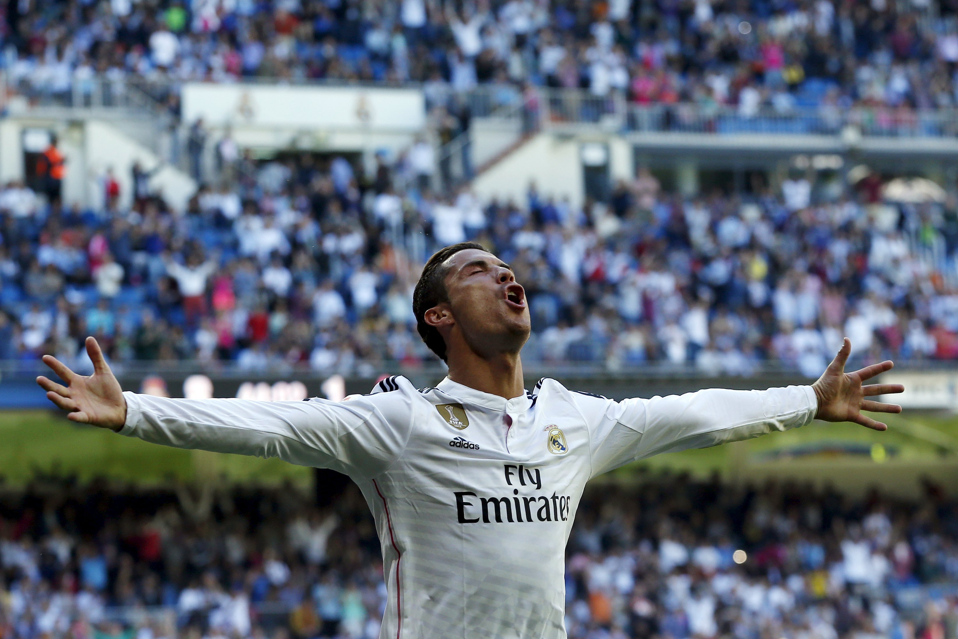 Real Madrid's Cristiano Ronaldo celebrates his fifth goal against Granada during their Spanish first division soccer match at Santiago Bernabeu stadium in Madrid