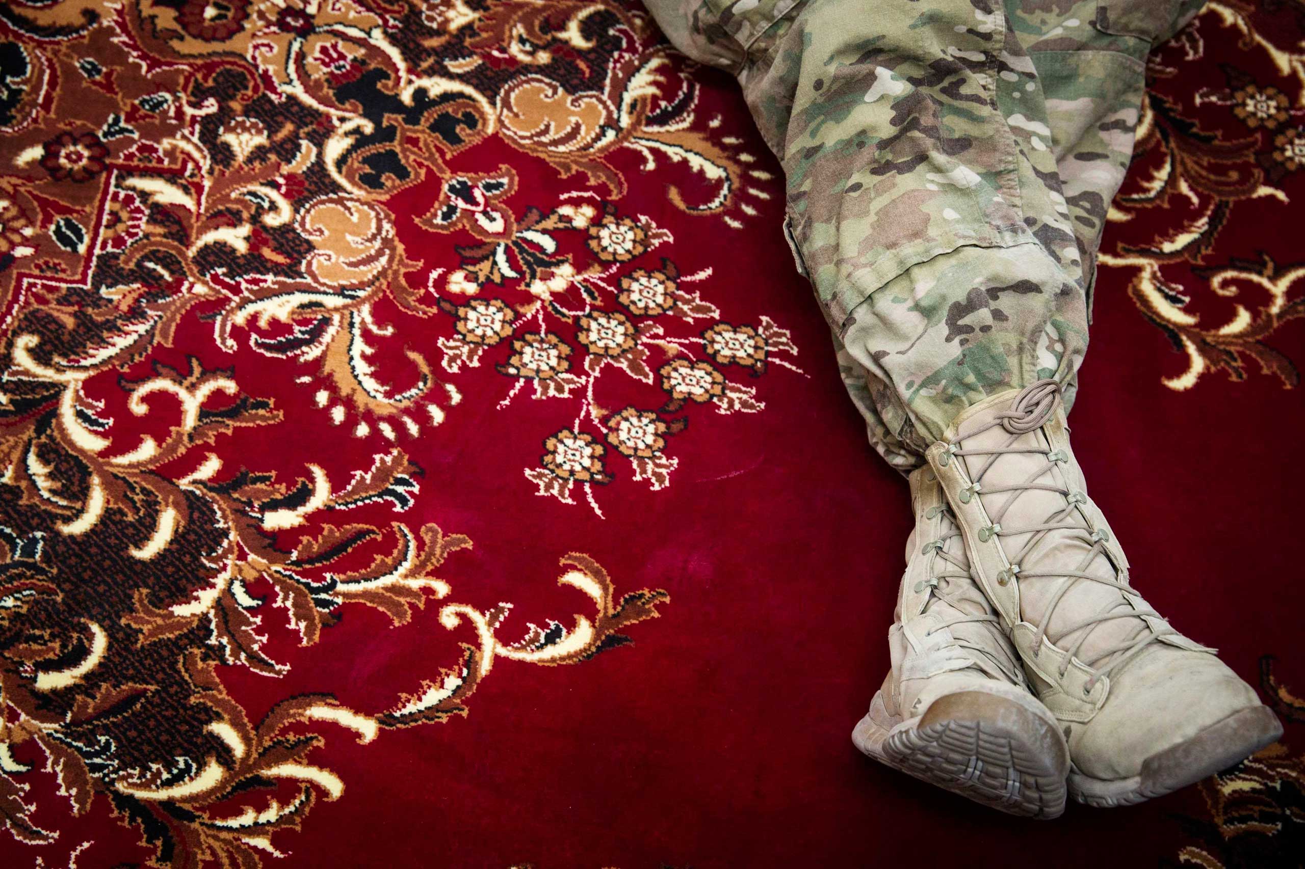 U.S. soldiers from the 3rd Cavalry Regiment listen to a translation of an advising meeting at an Afghan National Army base near forward operating base Gamberi in the Laghman province of Afghanistan