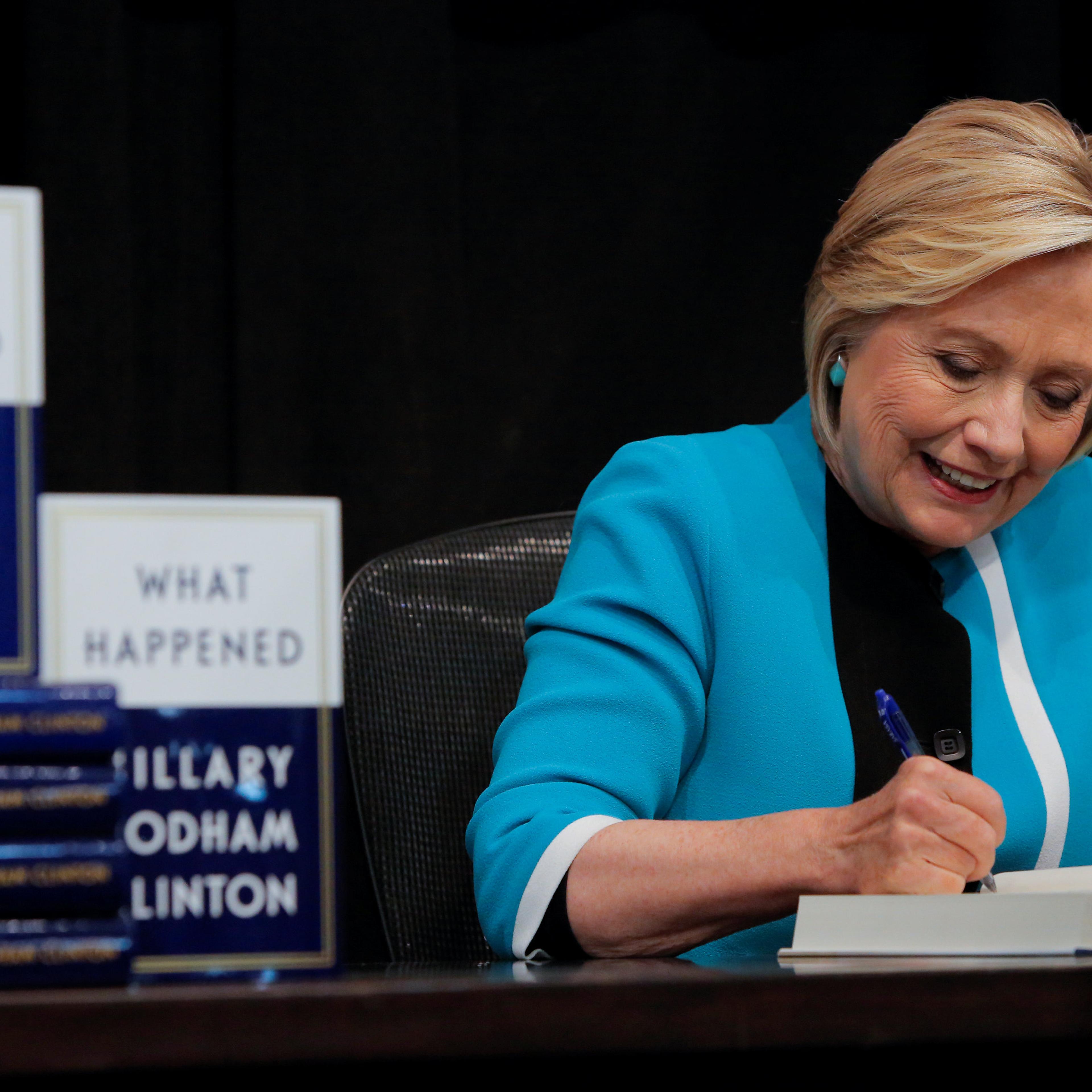 Former Secretary of State Hillary Clinton signs a copy of her new book 'What happened' at Barnes & Noble bookstore at Union Square in Manhattan, New York