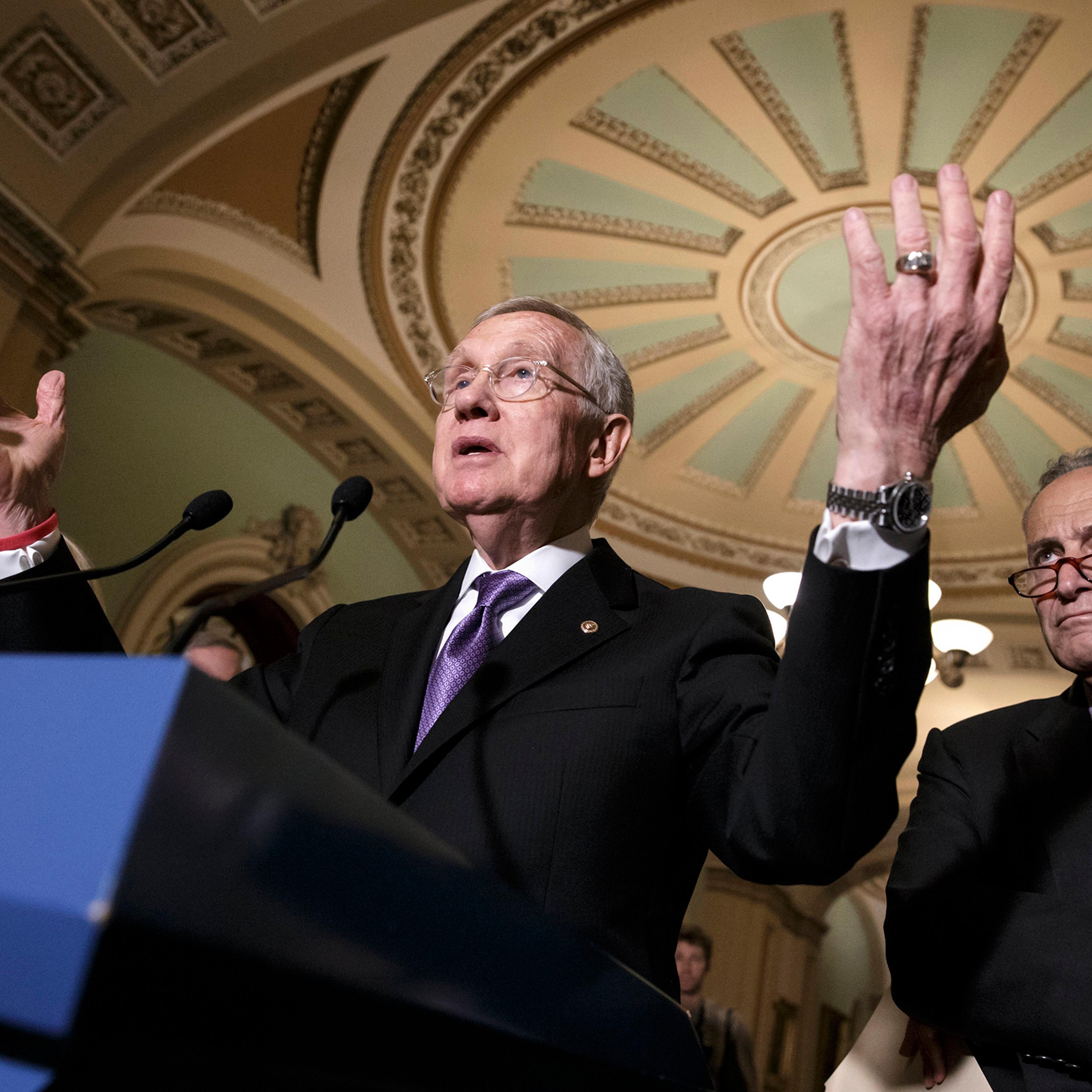 Senate Minority Leader Harry Reid of Nev., accompanied by Sen. Charles Schumer, right, faces reporters on Capitol Hill in Washington, June 28, 2016.