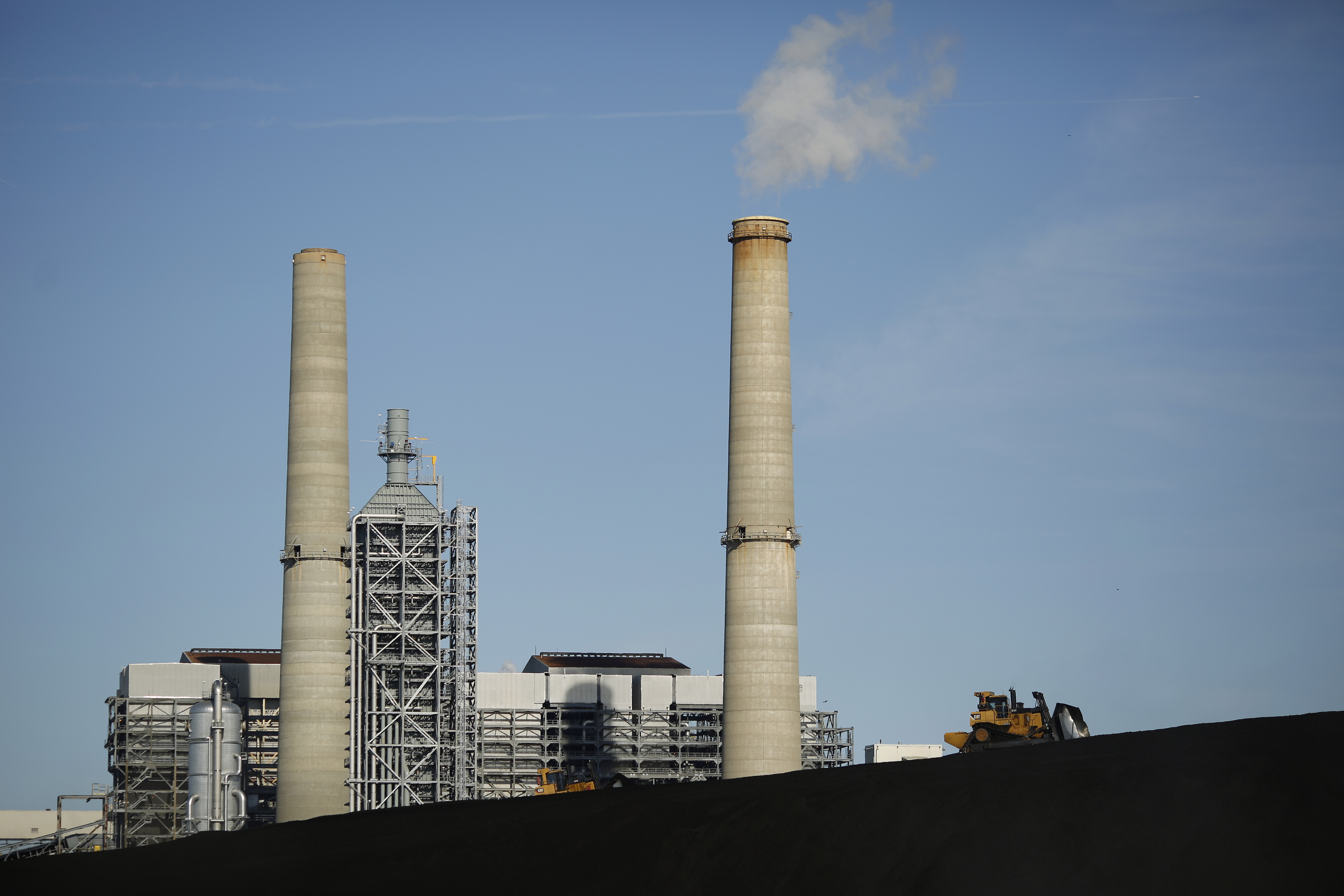 A bulldozer drives on a coal mound at the NRG Energy Inc. WA Parish generating station in Thompsons, Texas, U.S., on Thursday, Feb. 16, 2017. The plant is home to the Petra Nova Carbon Capture Project, a joint venture between NRG Energy and JX Nippon Oil
