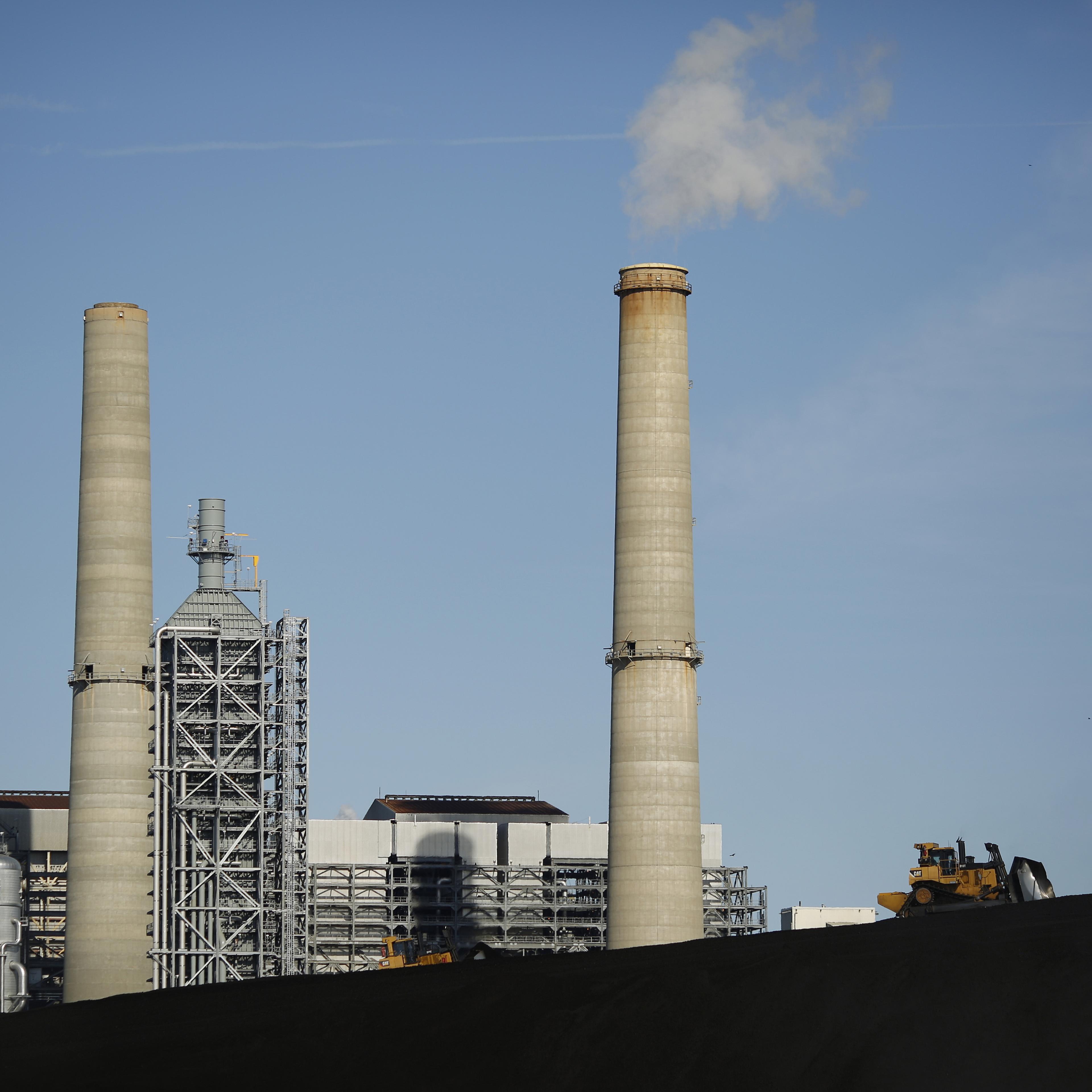 A bulldozer drives on a coal mound at the NRG Energy Inc. WA Parish generating station in Thompsons, Texas, U.S., on Thursday, Feb. 16, 2017. The plant is home to the Petra Nova Carbon Capture Project, a joint venture between NRG Energy and JX Nippon Oil