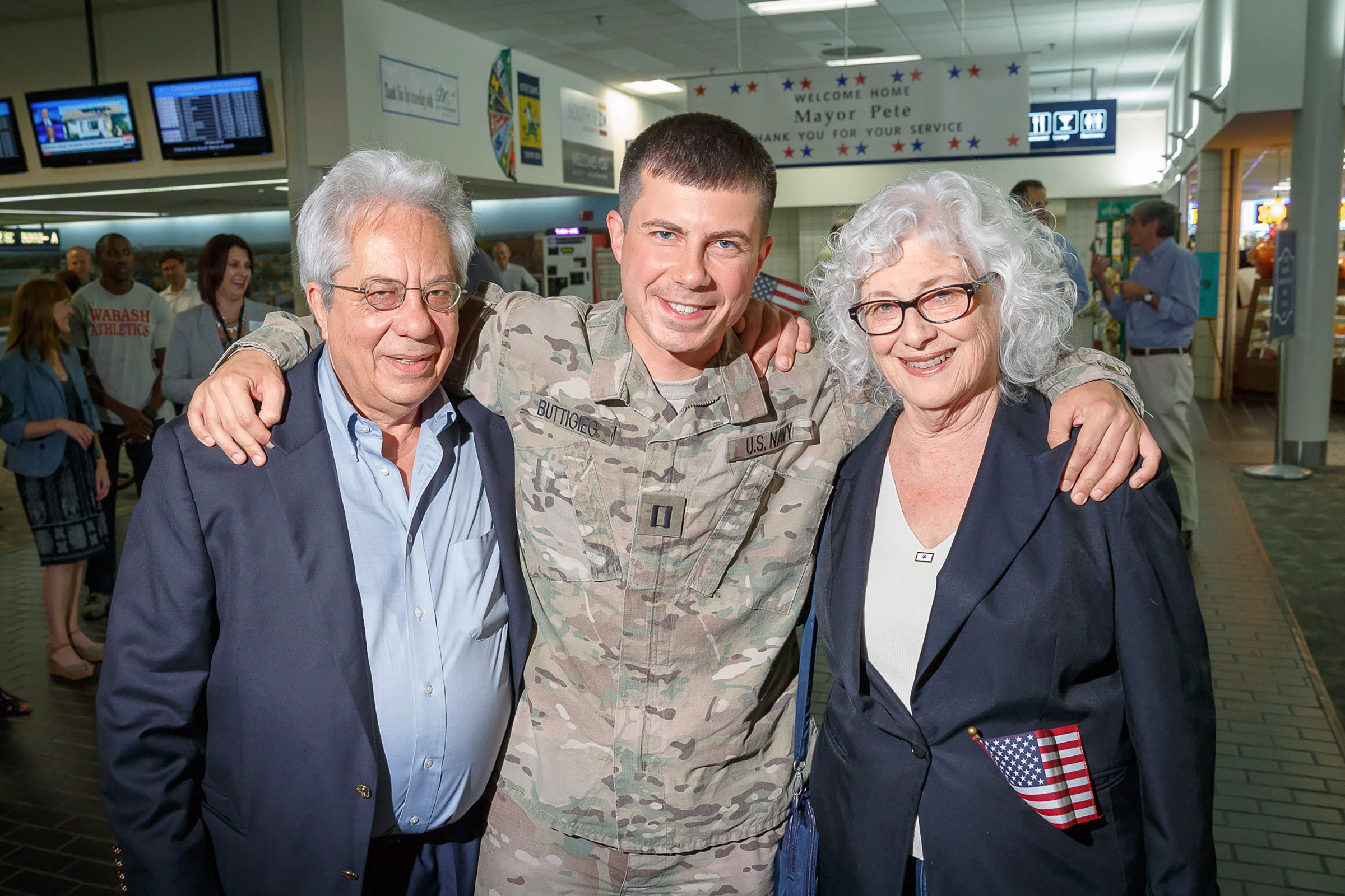 Lieutenant Buttigieg with his parents Joseph and Anne when he returned to South Bend after six months in Afghanistan, 2014.