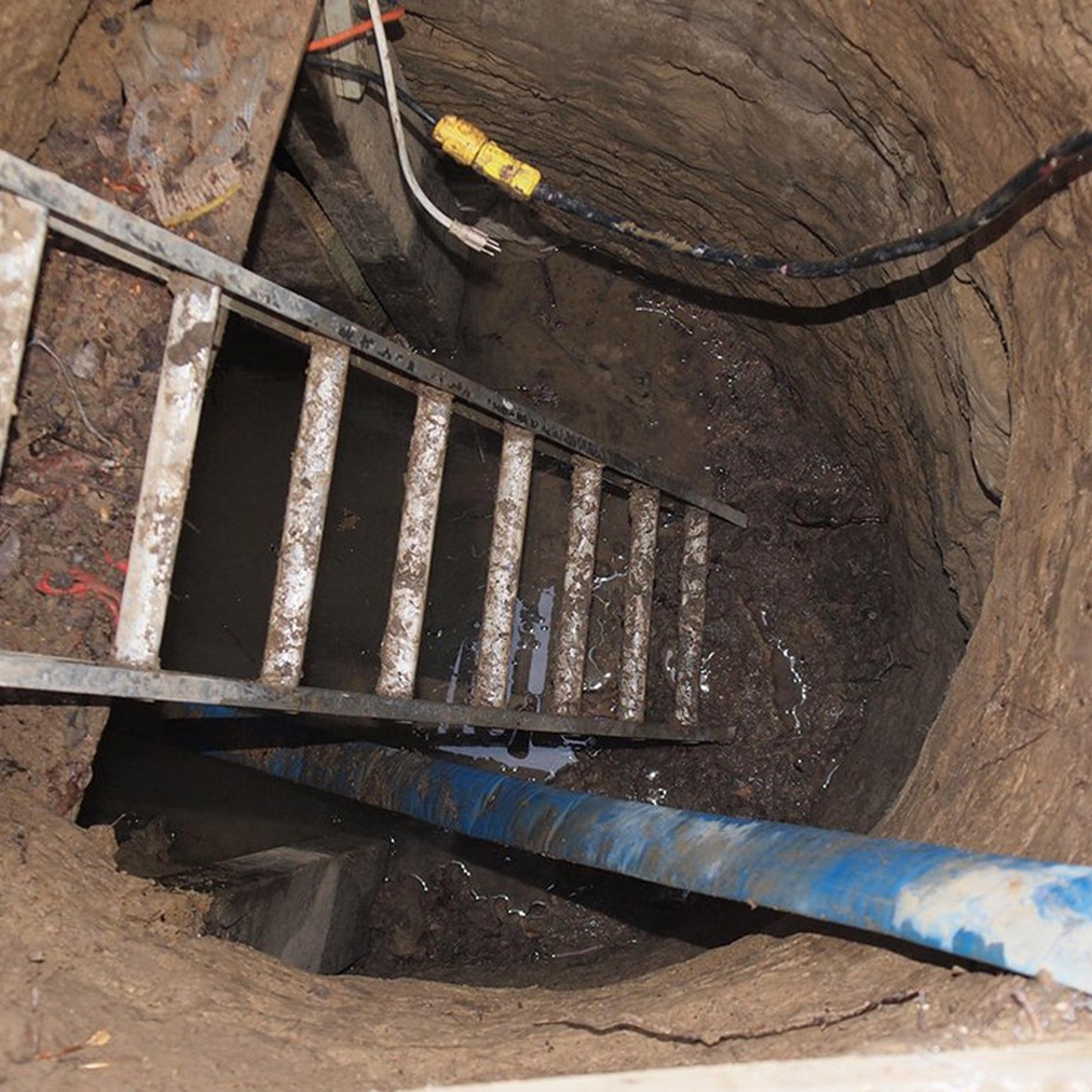 File photo of a ladder leading to a 33-foot-long tunnel supported using lumber which was found in Toronto