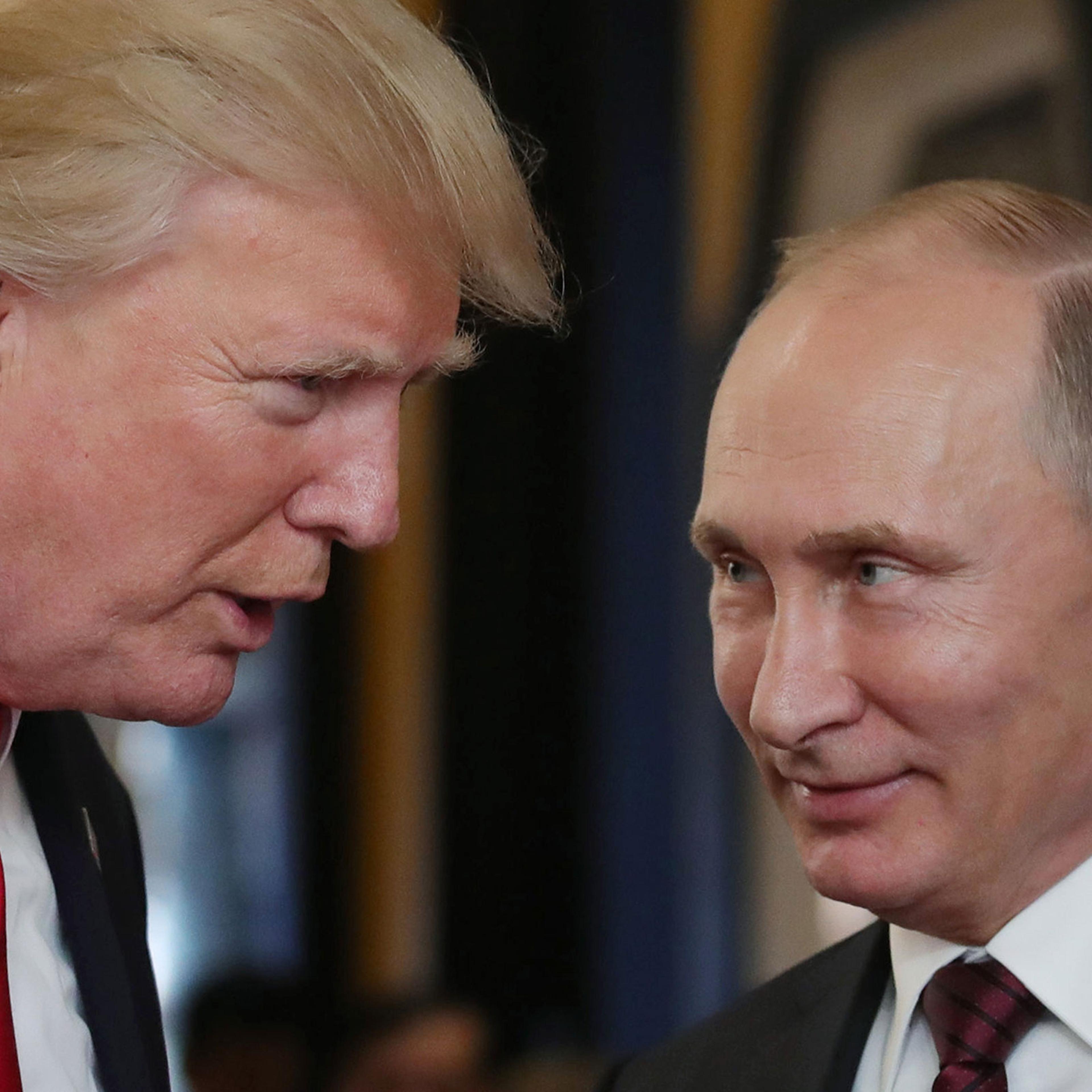 President Donald Trump chats with Russia's President Vladimir Putin as they attend the APEC Economic Leaders' Meeting in the central Vietnamese city of Danang on Nov. 11, 2017.