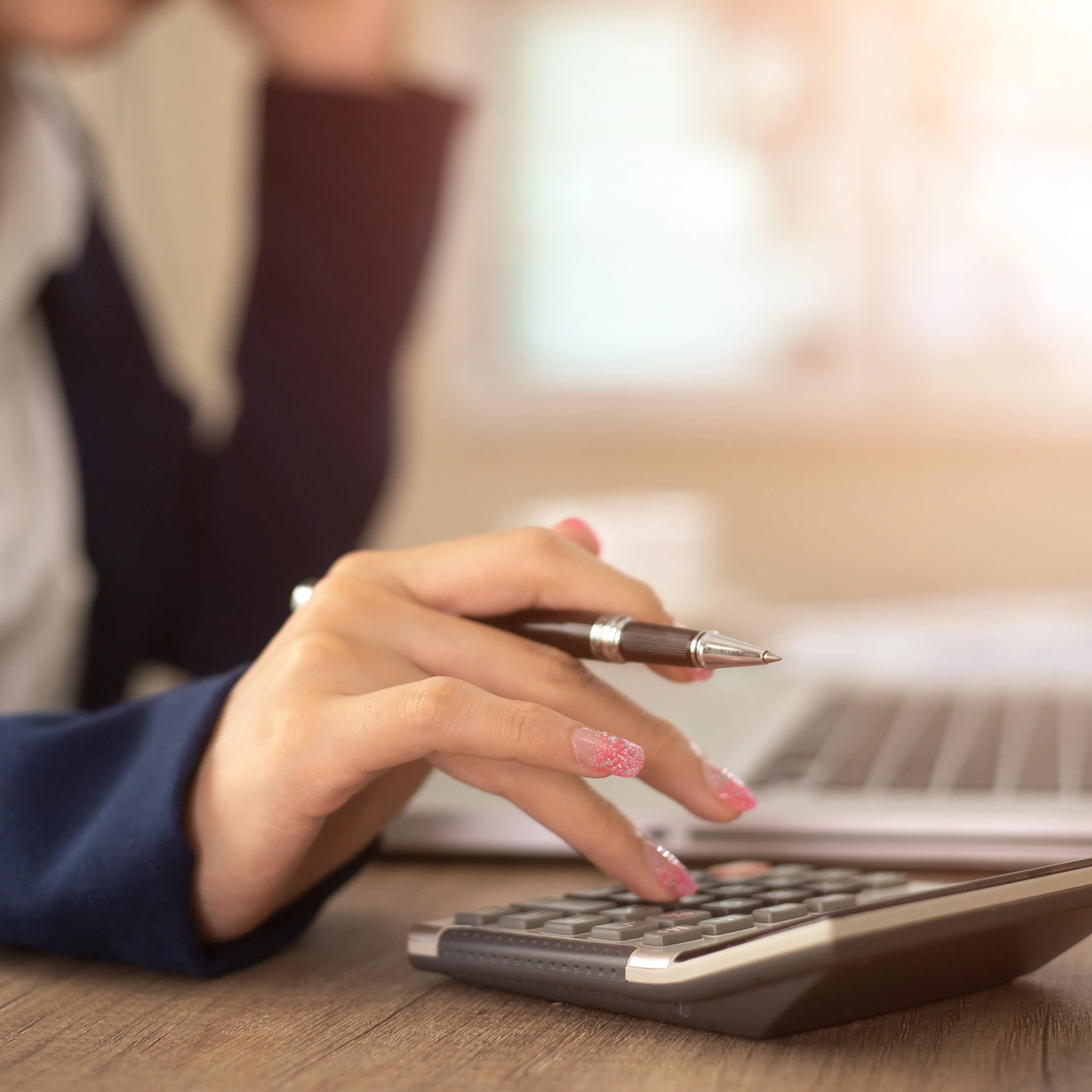 woman working with calculator, business document and laptop computer notebook