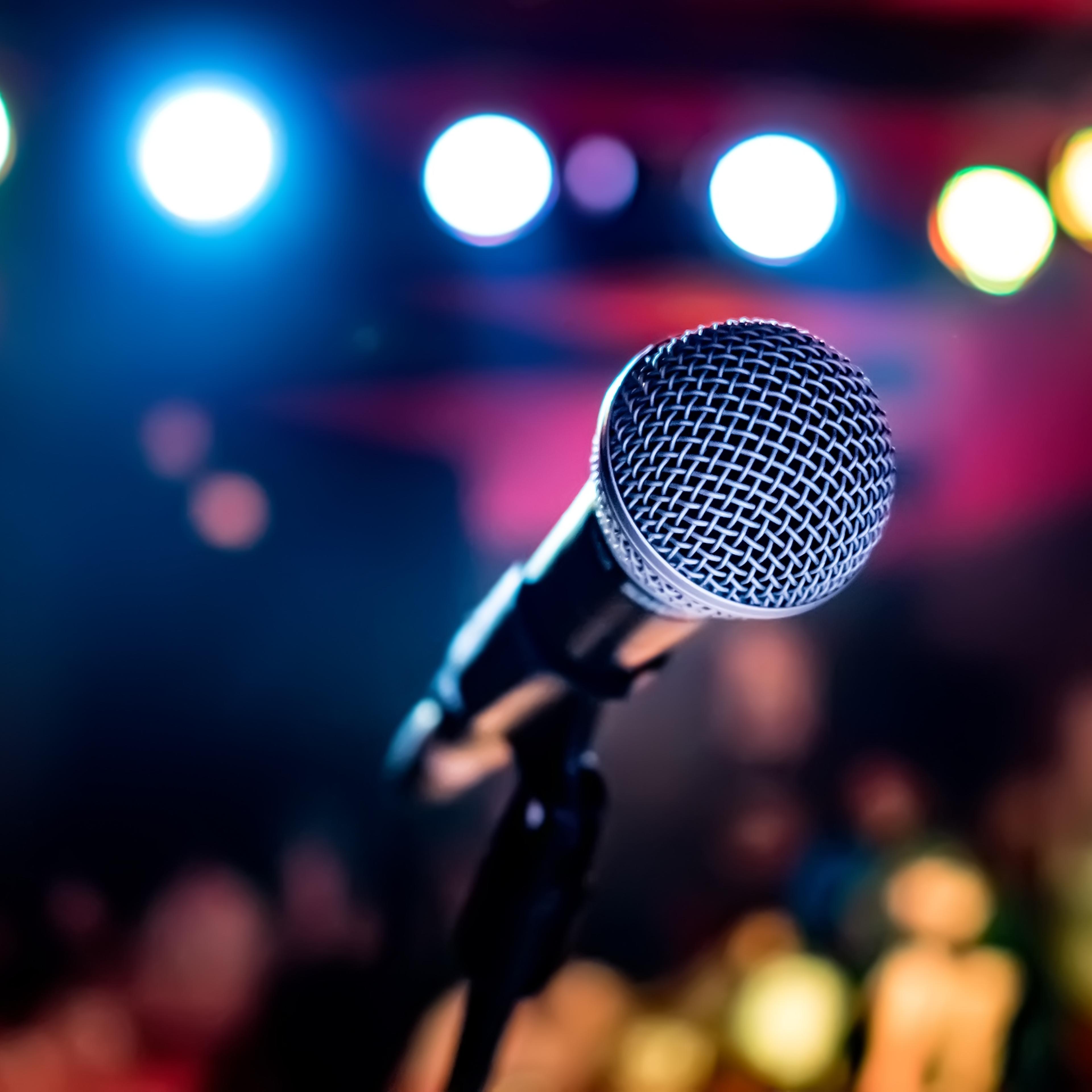Microphone on stage against a background of auditorium.