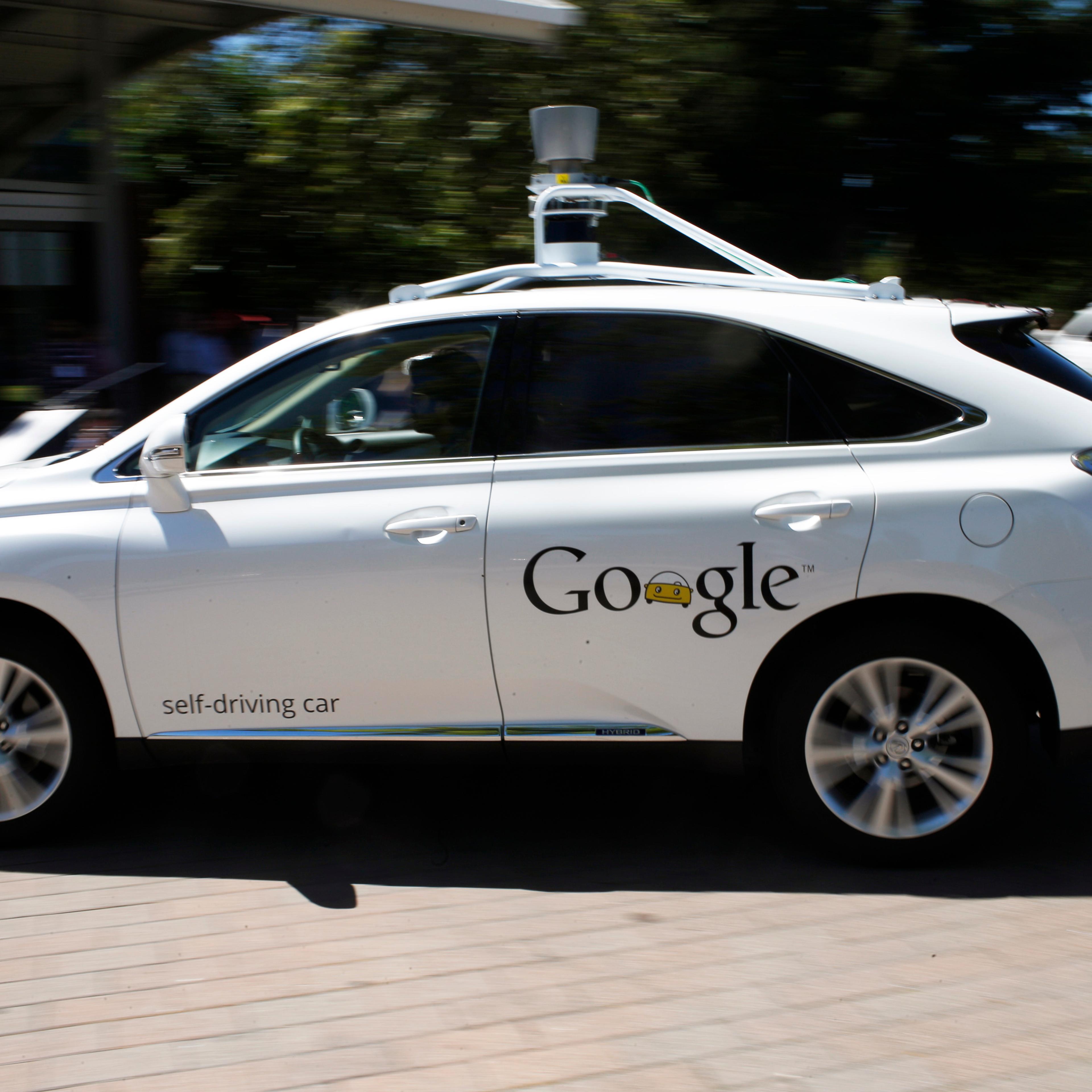 A Google self-driving vehicle drives around the parking lot at the Computer History Museum after a presentation in Mountain View, California