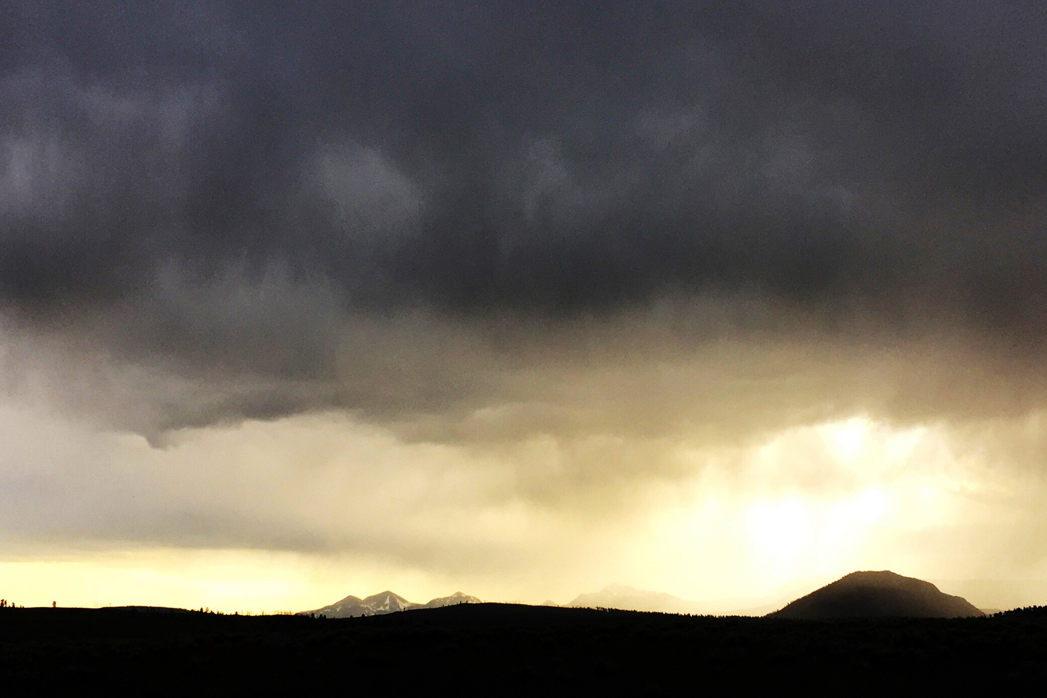 A rain shower moves over the Lamar Valley in Yellowstone National Park, Wyo. in June. A gaping hole in the earth has opened up in rural Wyoming, due in part to this year’s rainy spring.