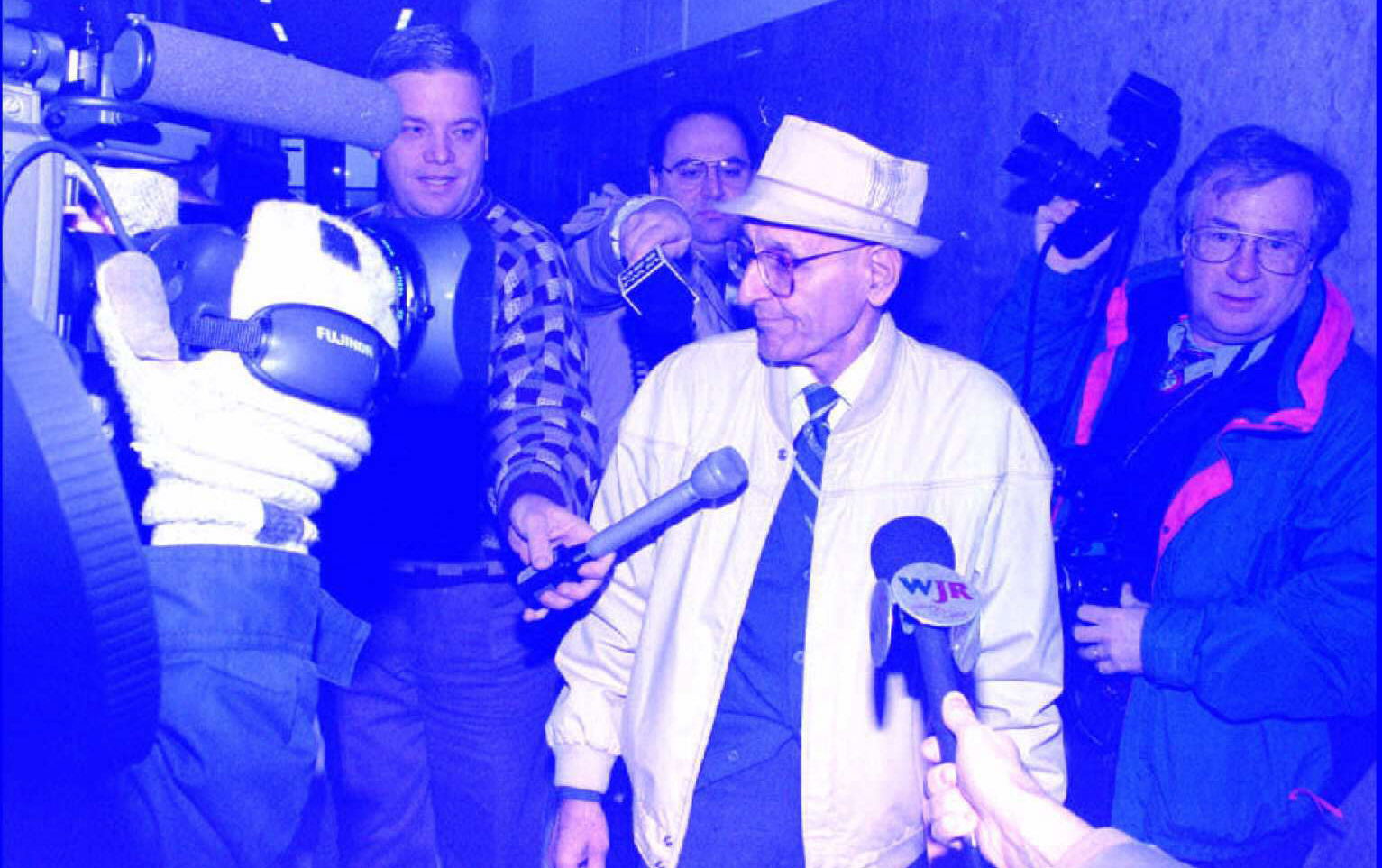 Doctor Jack Kevorkian walks through a crowd of rep