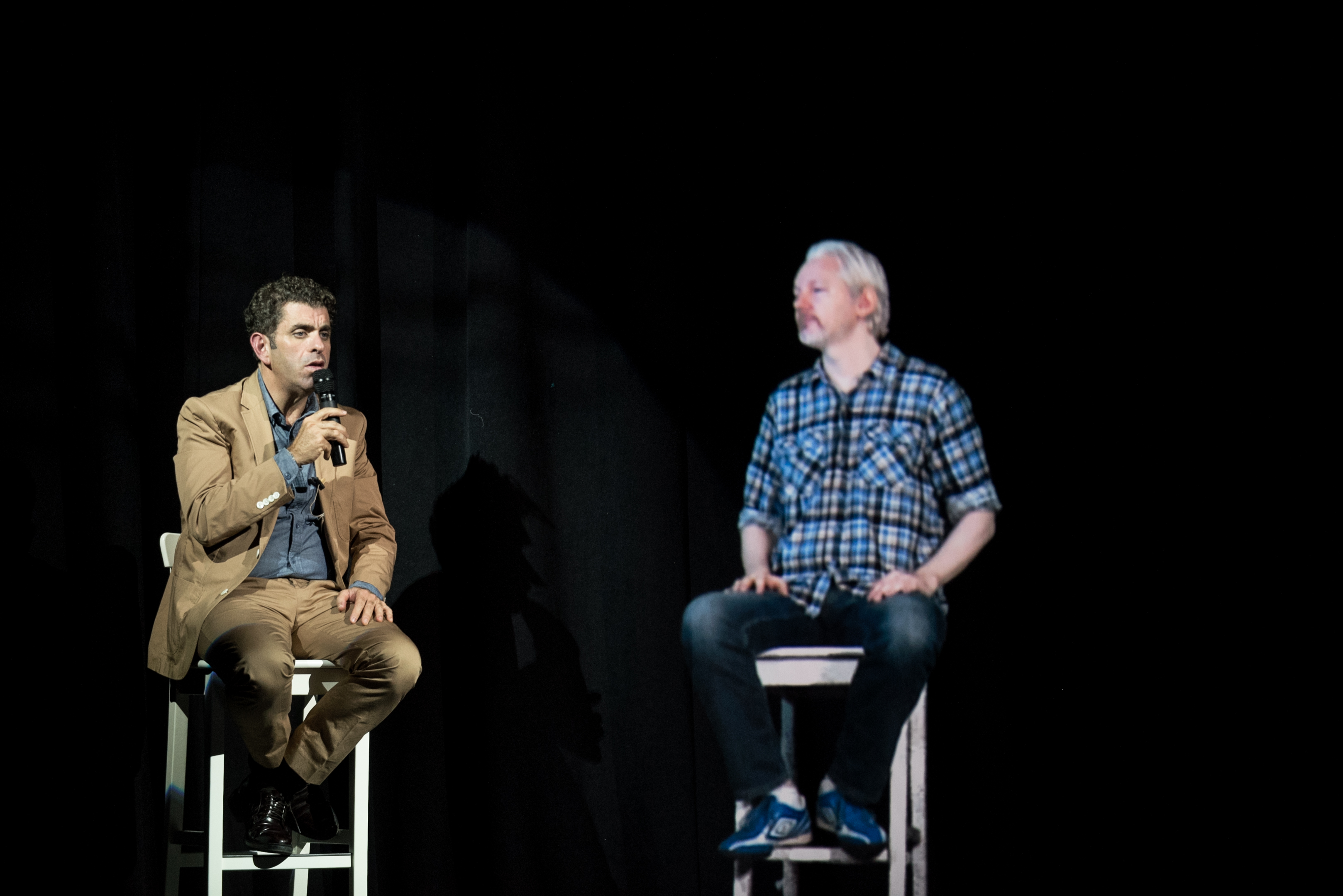 Julian Assange appears by hologram at The Nantucket Project on Sept. 28, 2014, alongside Eugene Jarecki.