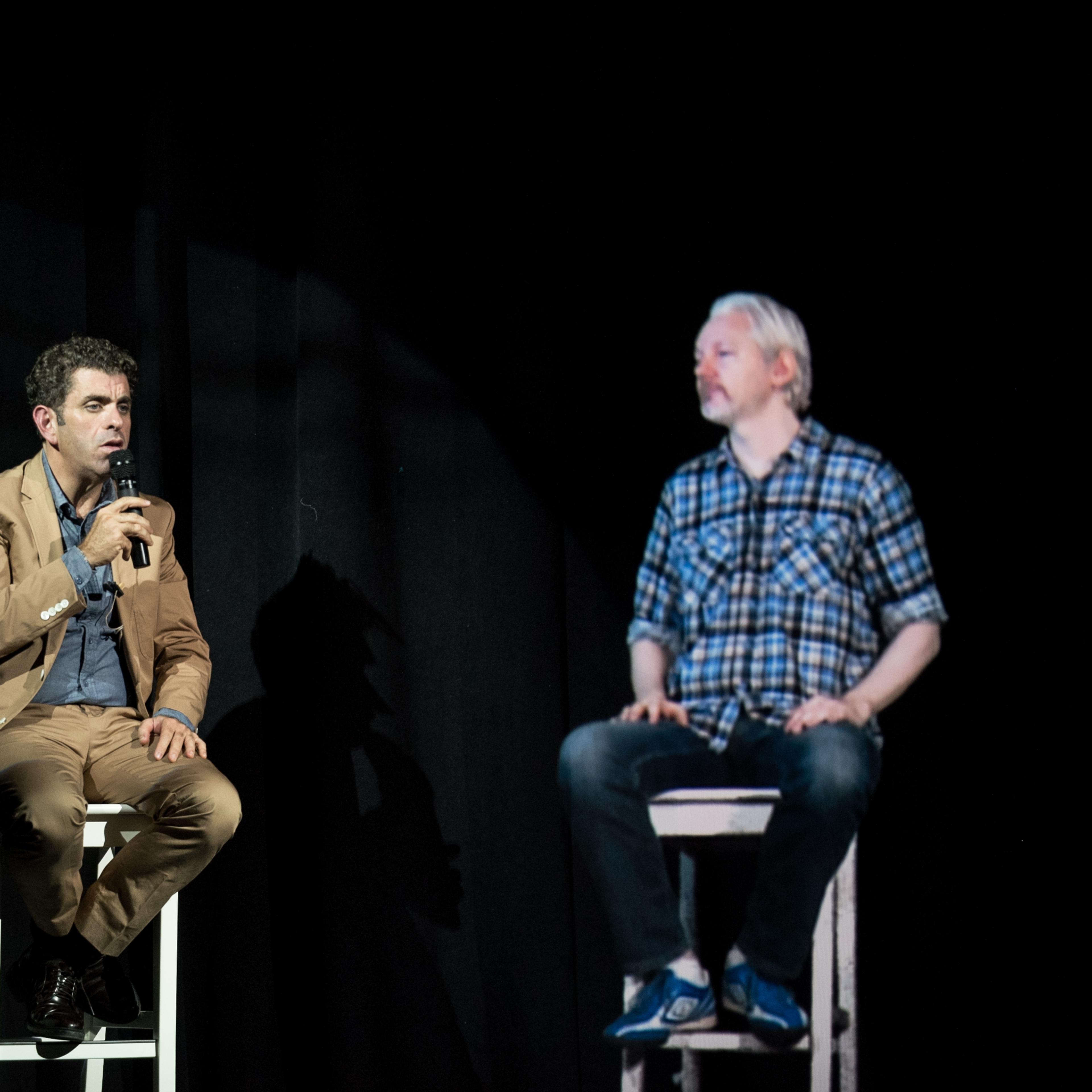 Julian Assange appears by hologram at The Nantucket Project on Sept. 28, 2014, alongside Eugene Jarecki.