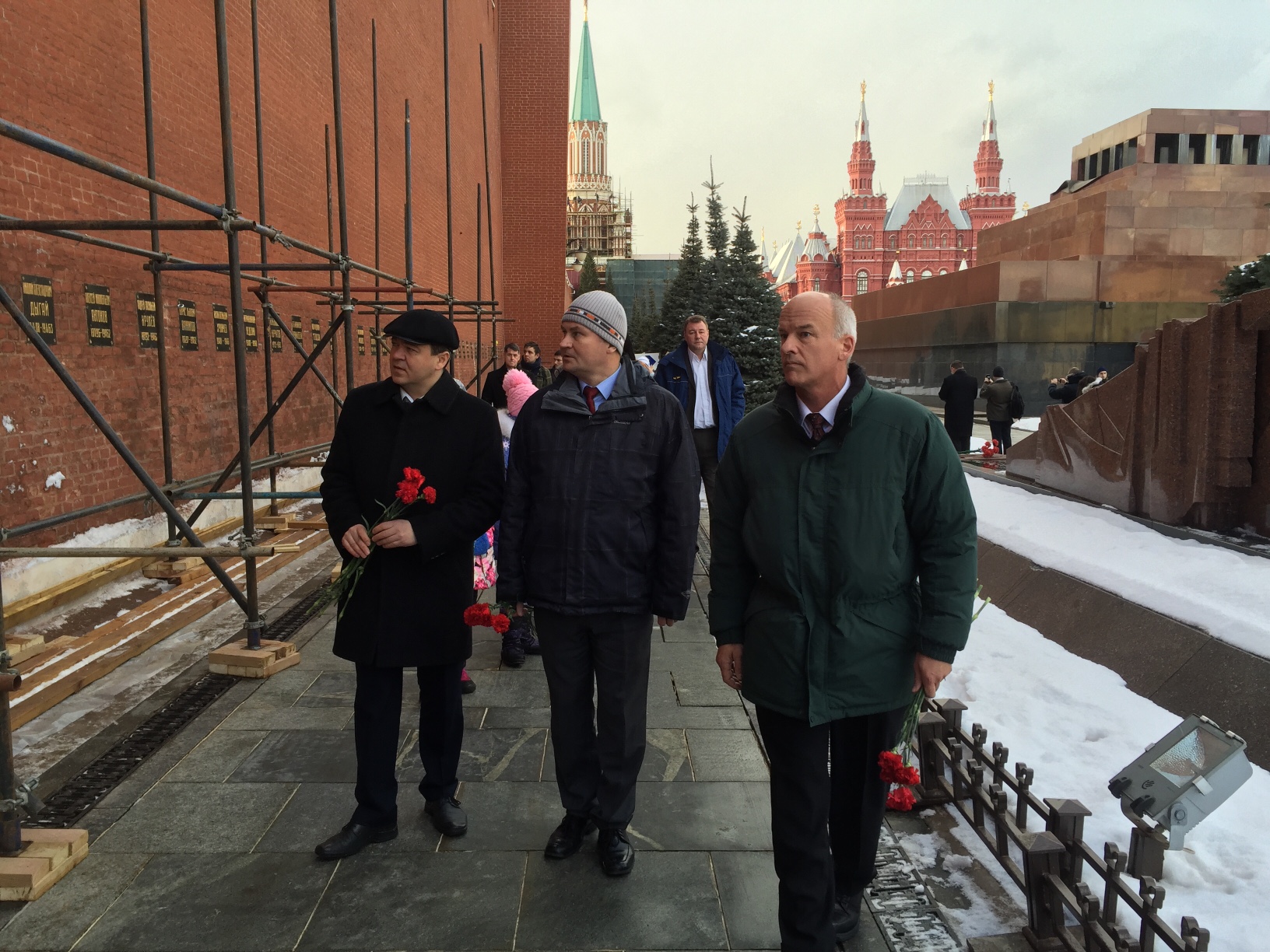 NASA astronaut Jeff Williams, right, along with Russian Cosmonauts Oleg Skripochka, left, and Alexey Ovchnin prepare for a ceremonial laying of flowers at the graves of Yuri Gagarin and Sergey Korolev outside the Kremlin near Red Square in Moscow on Friday, Feb. 26, 2016.