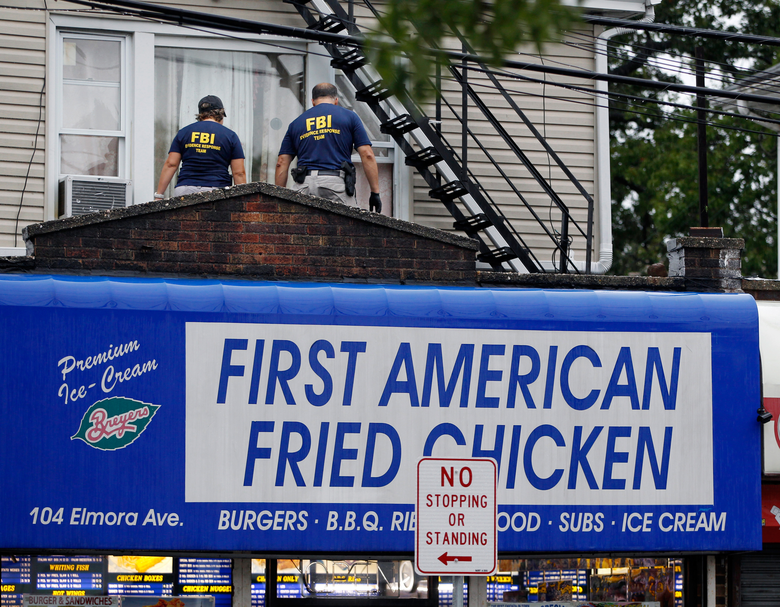 FBI agents walk around the roof outside an apartment during an investigation at a building Monday, Sept. 19, 2016, in Elizabeth, N.J. FBI agents are searching the apartment that is tied to Ahmad Khan Rahami wanted for questioning in the New York City bom