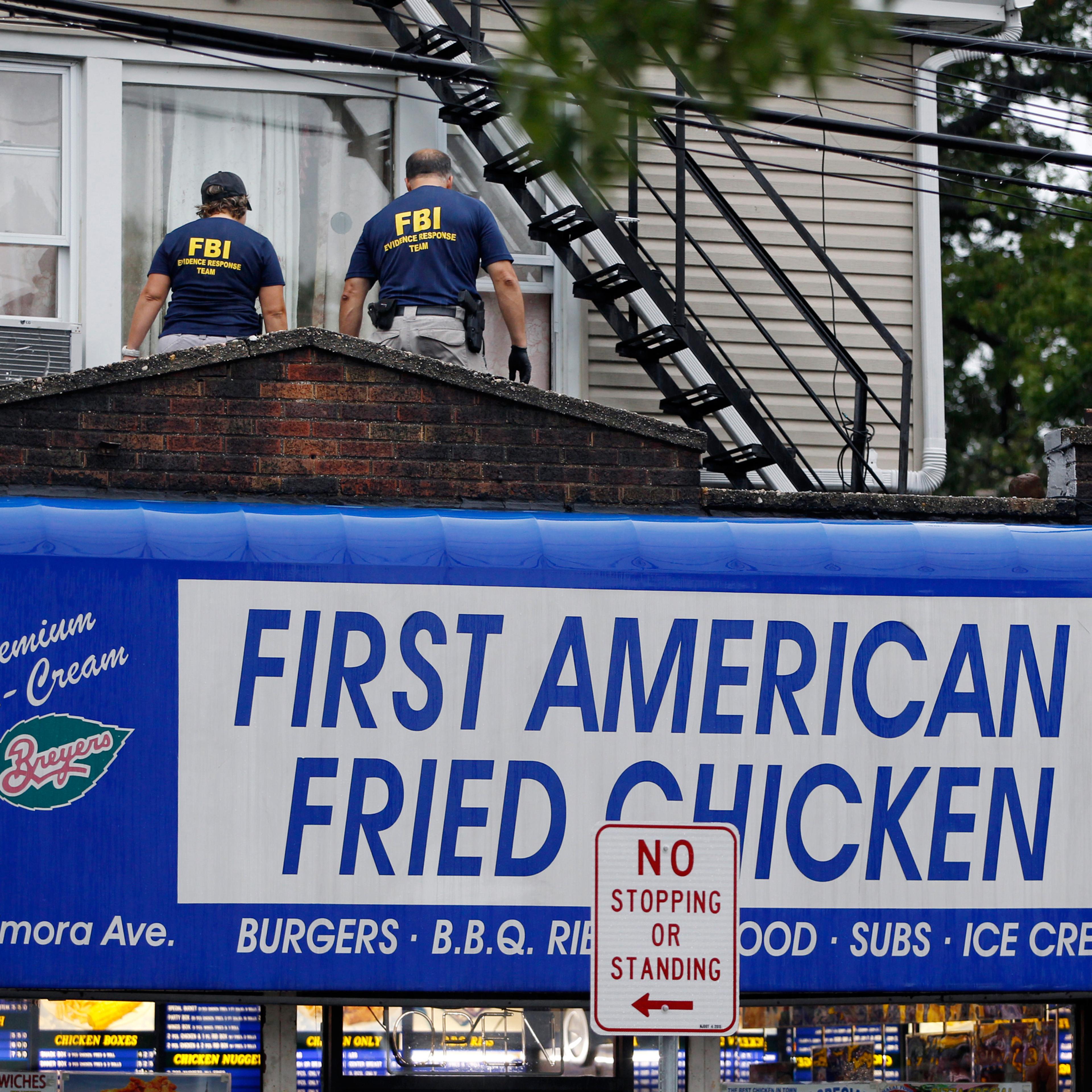 FBI agents walk around the roof outside an apartment during an investigation at a building Monday, Sept. 19, 2016, in Elizabeth, N.J. FBI agents are searching the apartment that is tied to Ahmad Khan Rahami wanted for questioning in the New York City bom