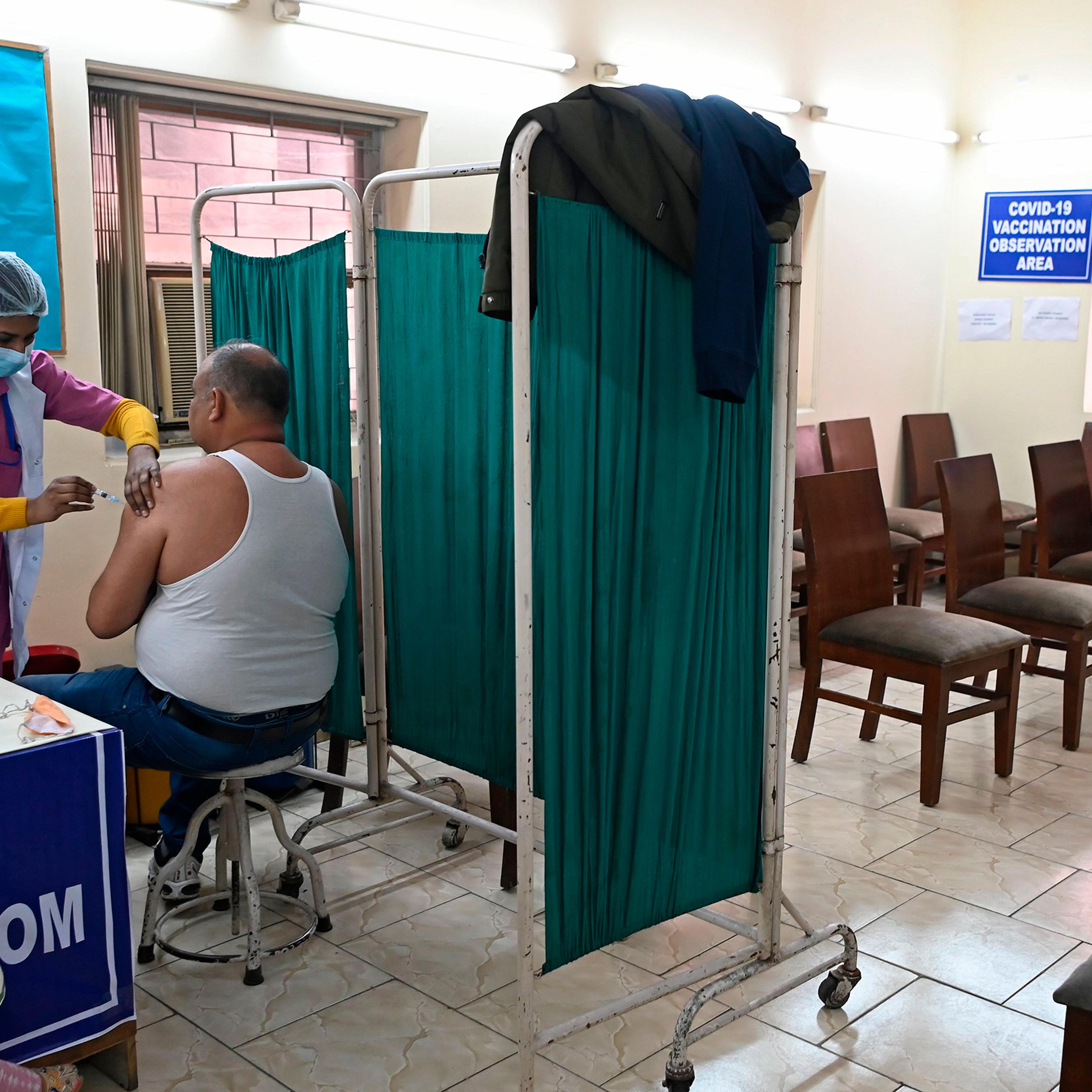 A medical worker inoculates a frontline worker with a Covid-19 vaccine at a vaccination centre in New Delhi on Feb. 13