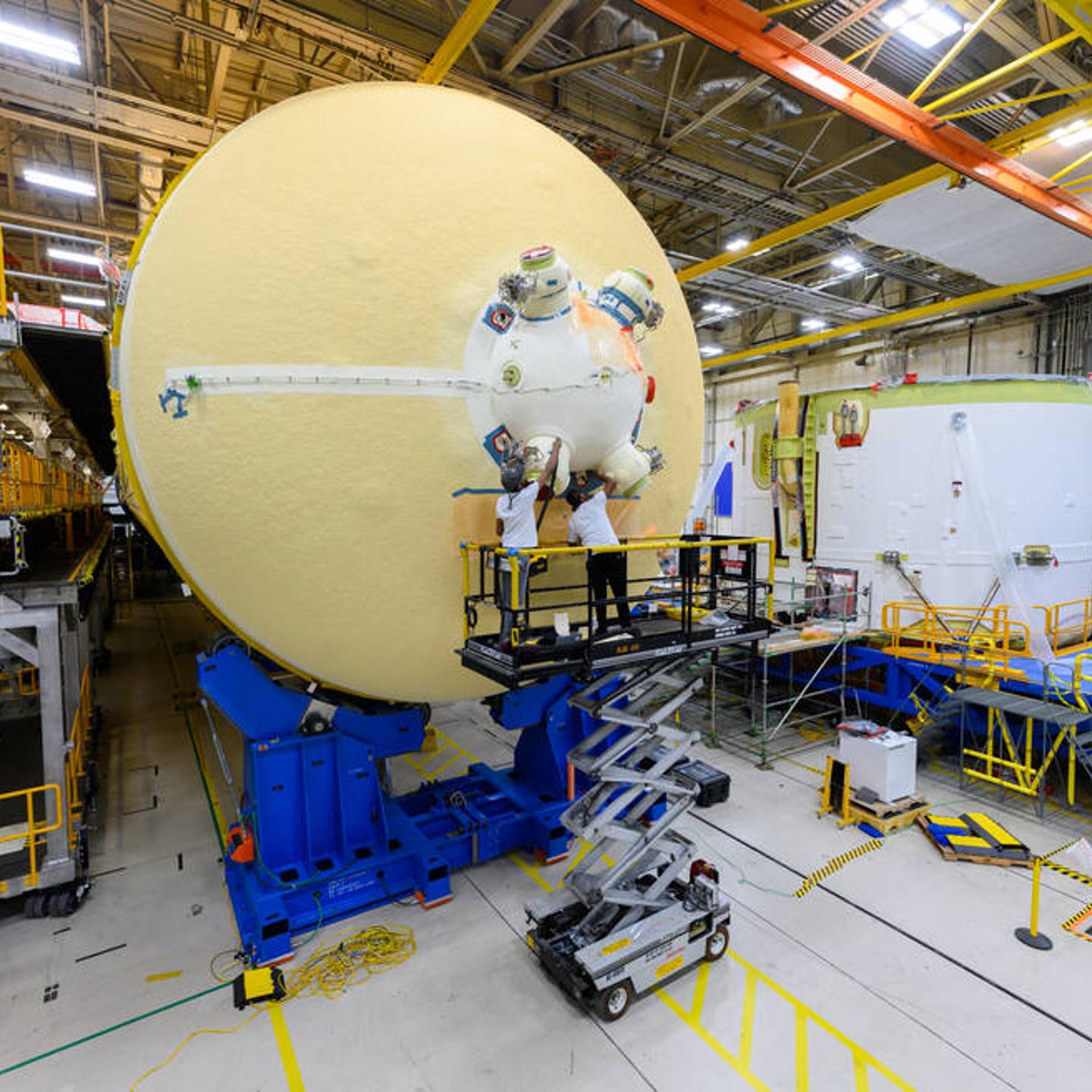Crews at NASA's Michoud Assembly Plant work on the core stage of an SLS moon rocket