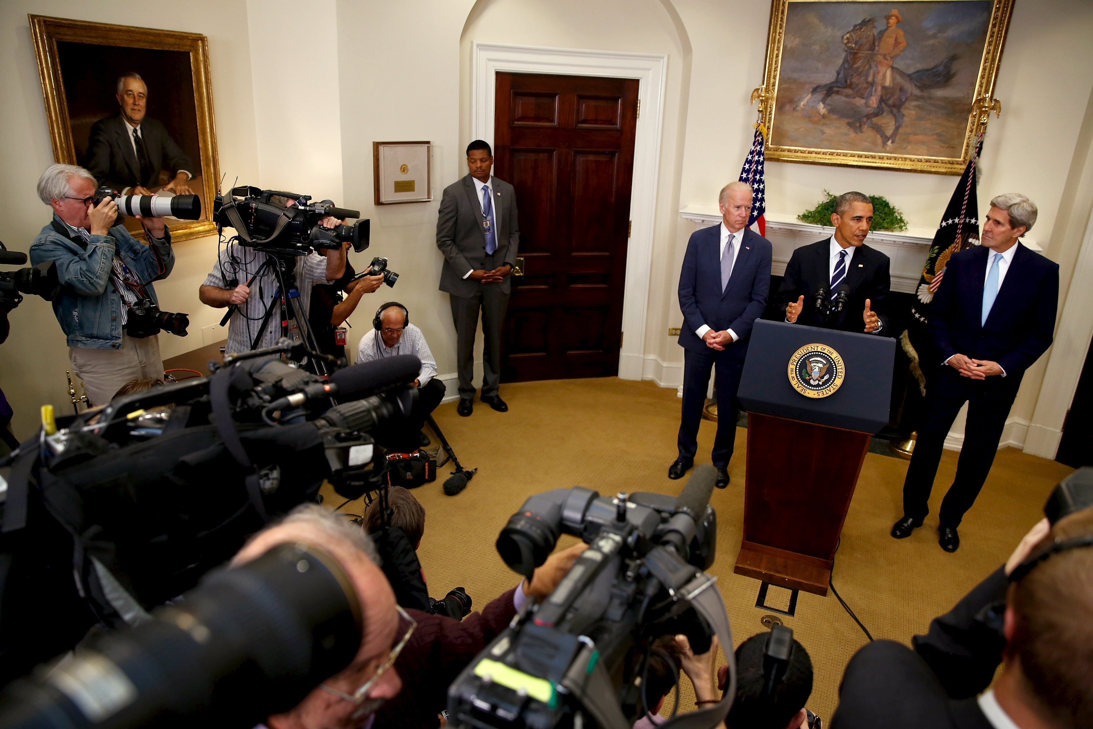 Obama, flanked by Biden and Kerry, delivers a statement on the Keystone XL pipeline at the White House in Washington