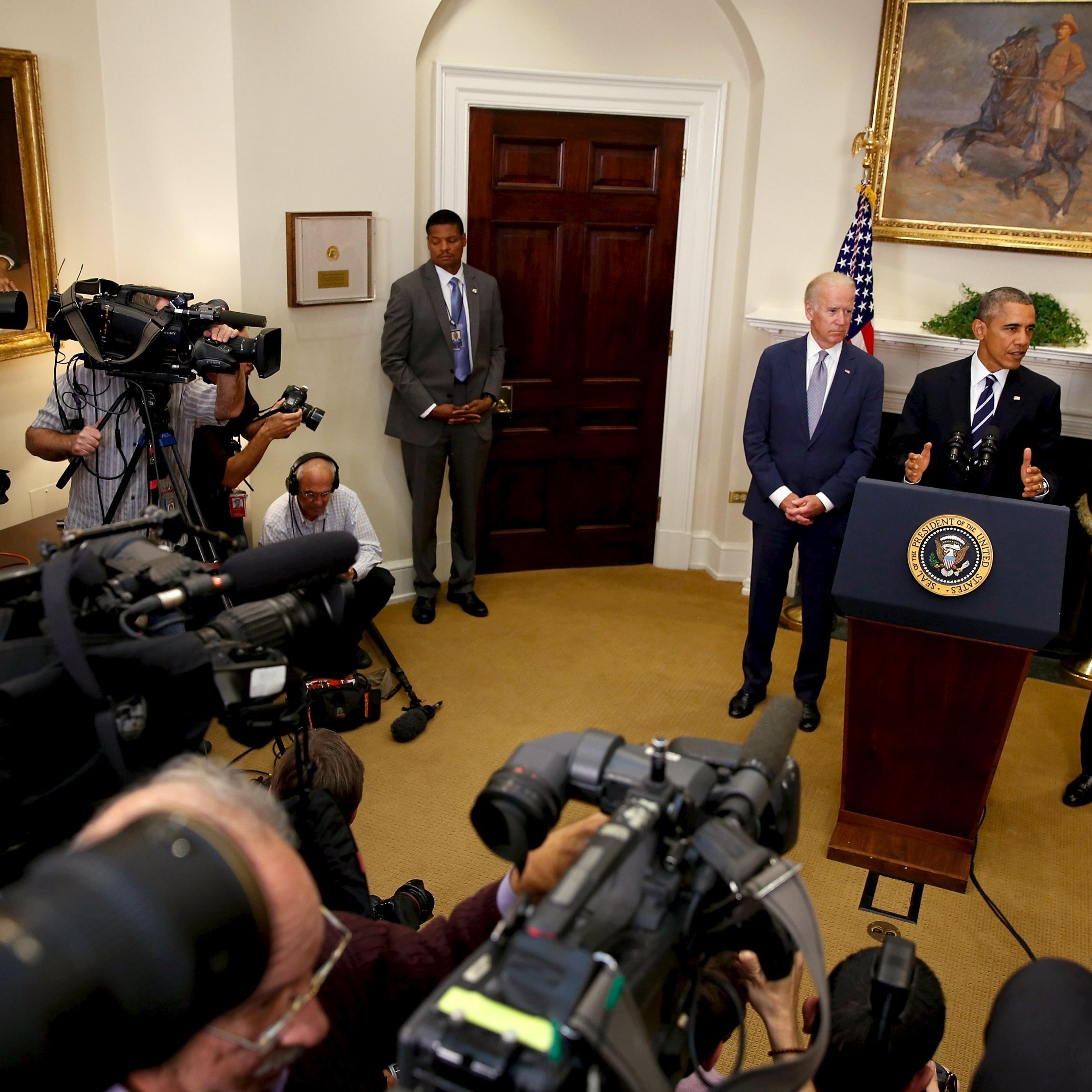 Obama, flanked by Biden and Kerry, delivers a statement on the Keystone XL pipeline at the White House in Washington
