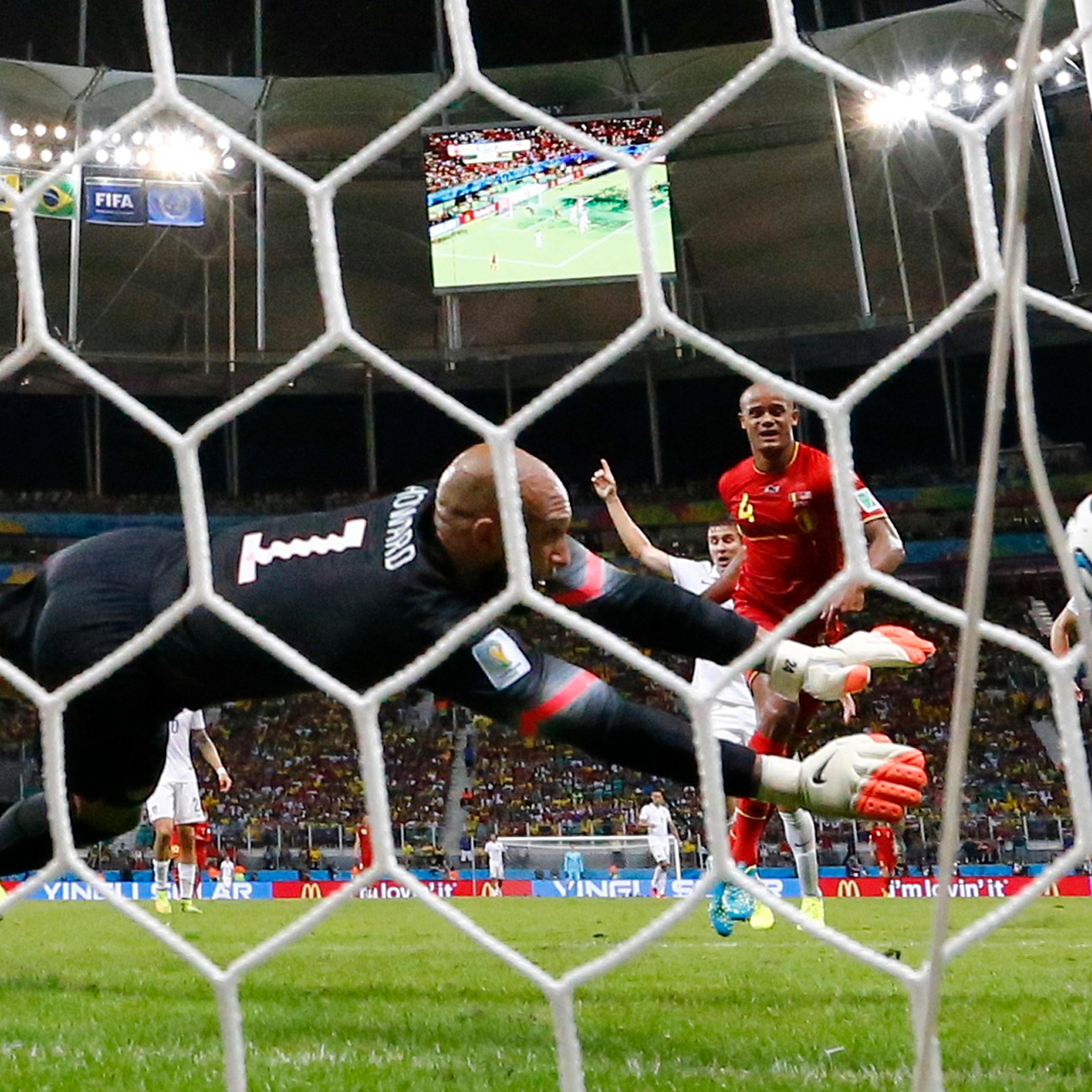 Goalkeeper Howard of the U.S. blocks a shot from Belgium's Kompany during their 2014 World Cup round of 16 game at the Fonte Nova arena in Salvador