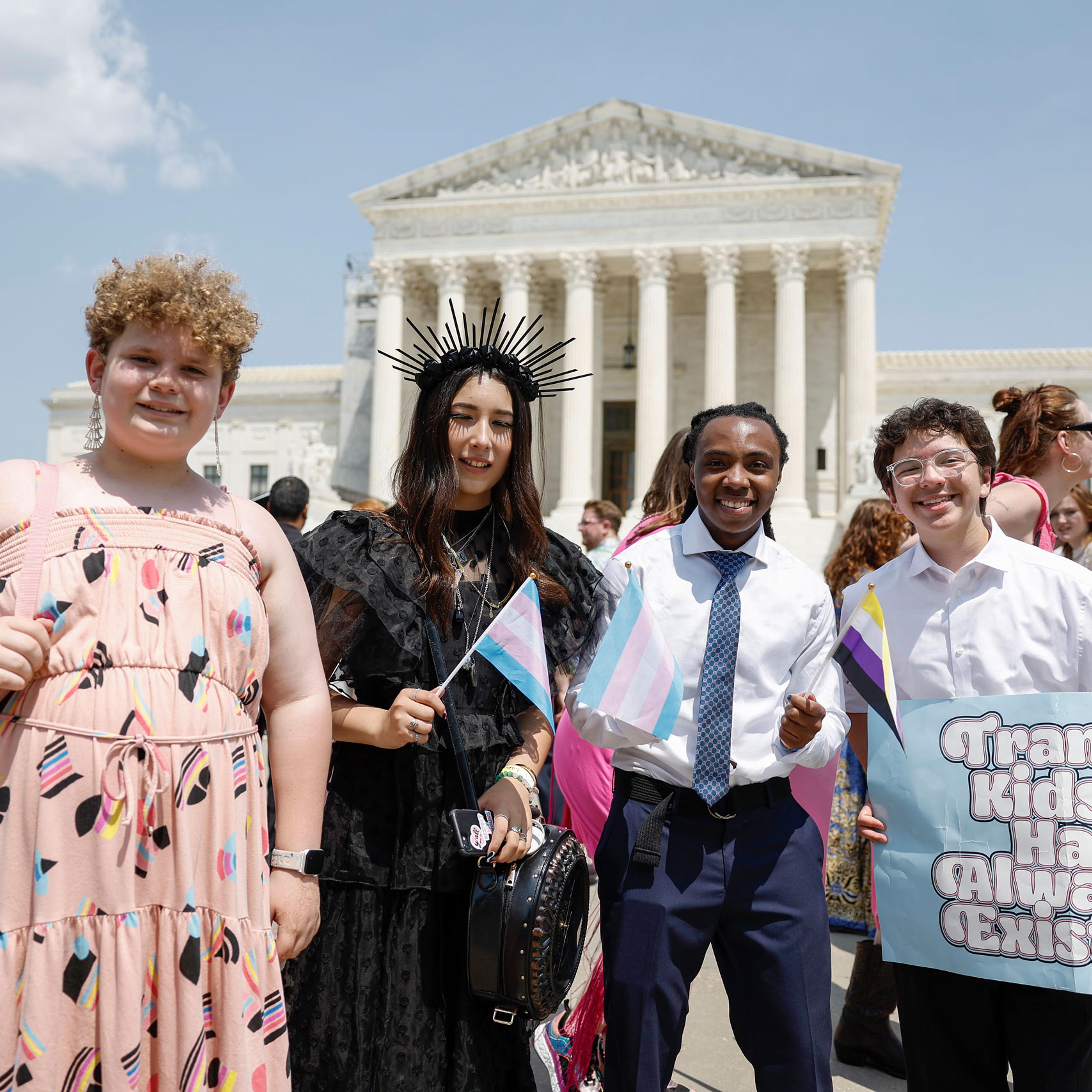 Grayson McFerrin, 12, Libby Gonzales, 13, Hobbes Chukumba, 16, and Daniel Trujillo, 15, the organizers of the “Trans Youth Prom” pose for a photo in front of the U.S. Supreme Court Building in Washington, D.C.