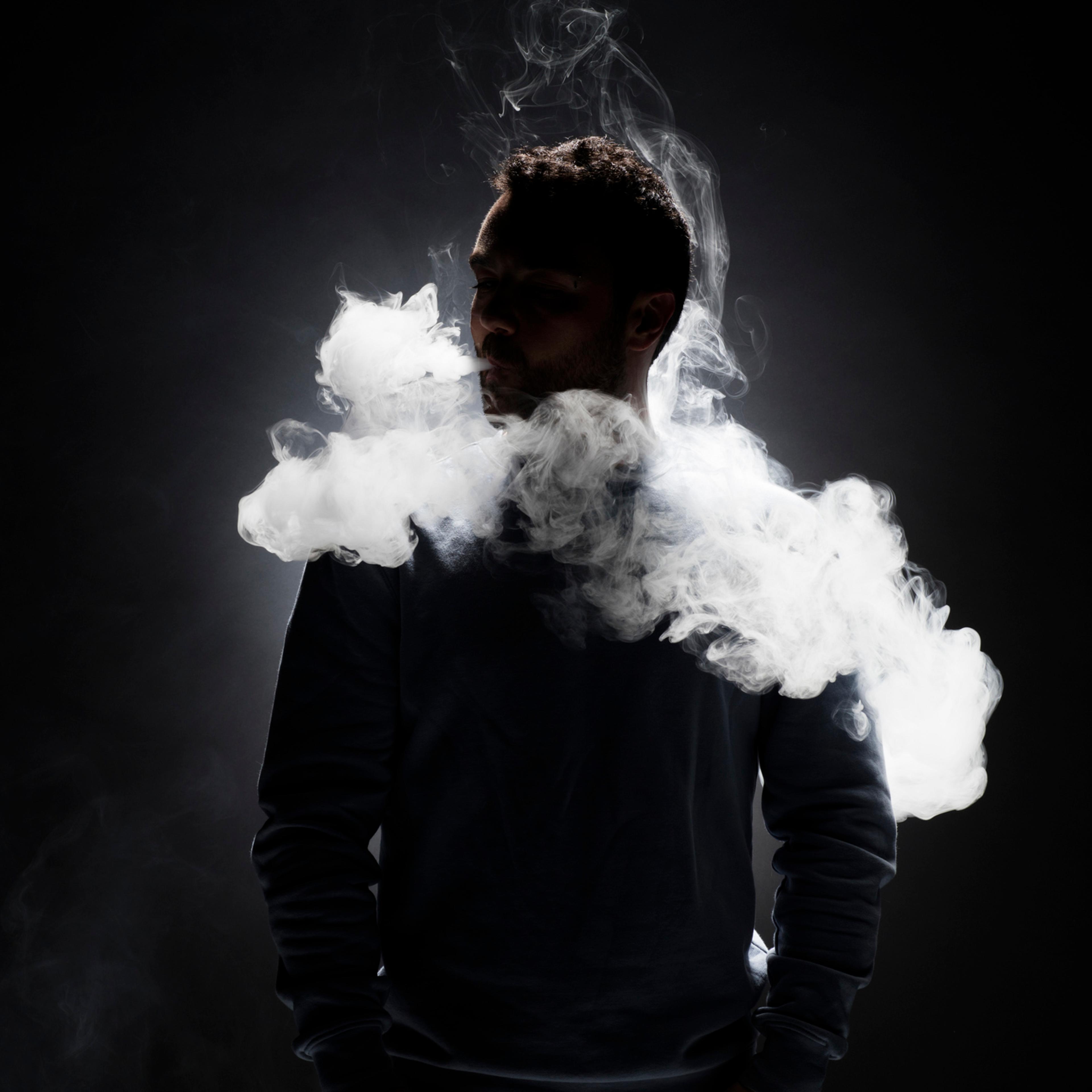 man vaping on black background