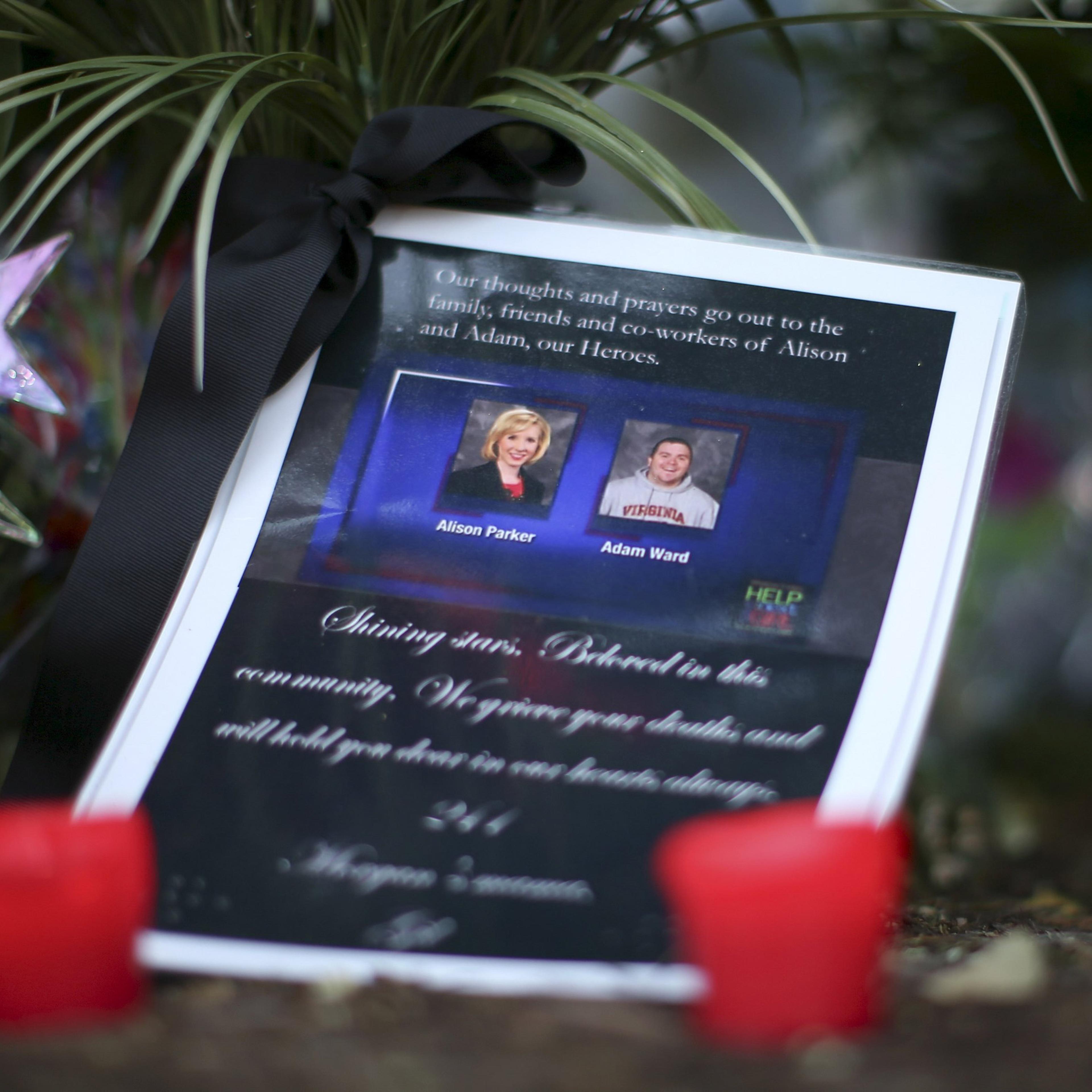 REFILE - CORRECTING TYPO IN ADAM WARD'S LAST NAMEA picture of slain journalists Alison Parker and Adam Ward is seen next to candles at a memorial outside of the offices for WDBJ7 in Roanoke, Virginia August 27, 2015. Parker, 24, and Ward, 27, were shot d