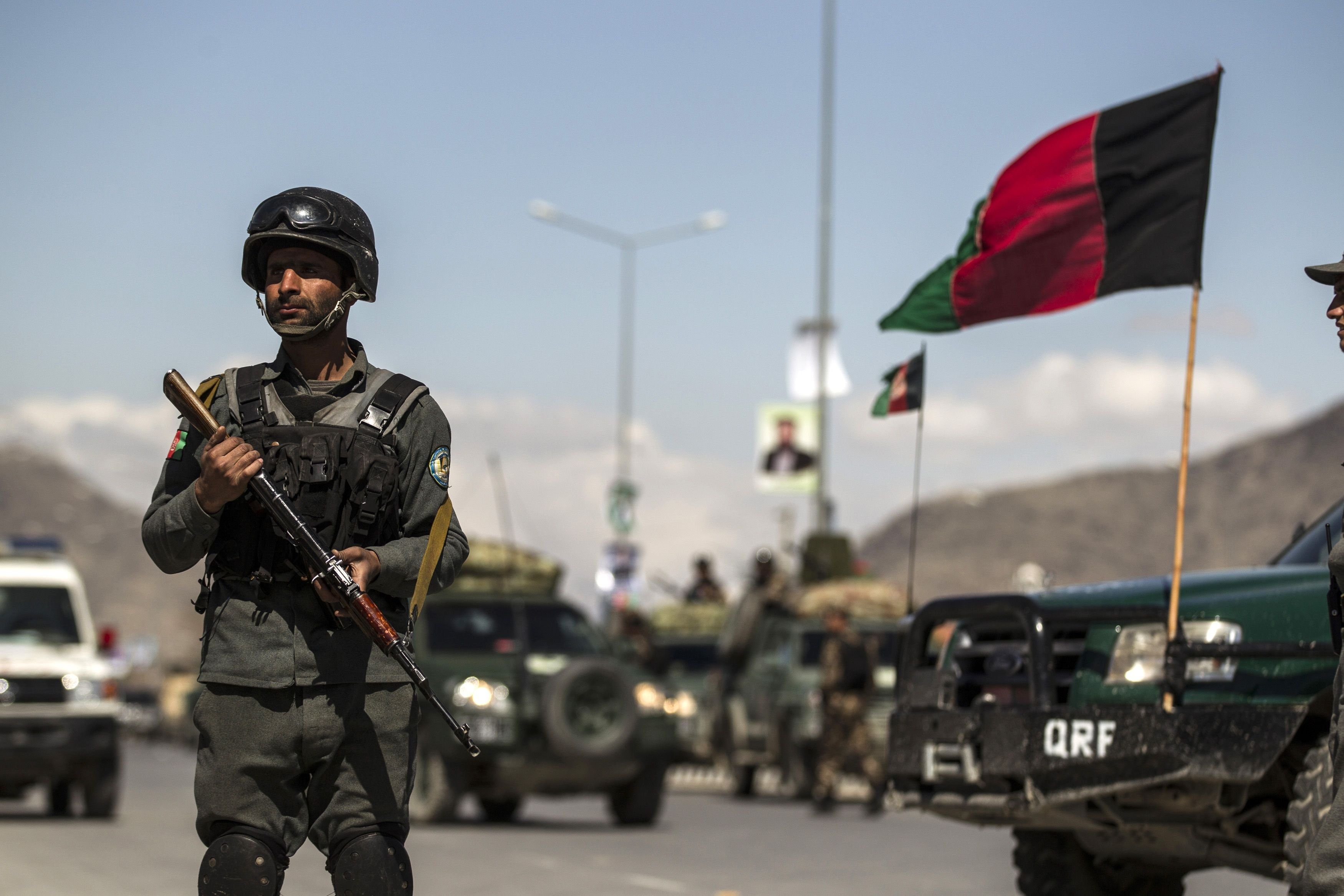 An Afghan policeman stands guard near the site of an attack in Kabul