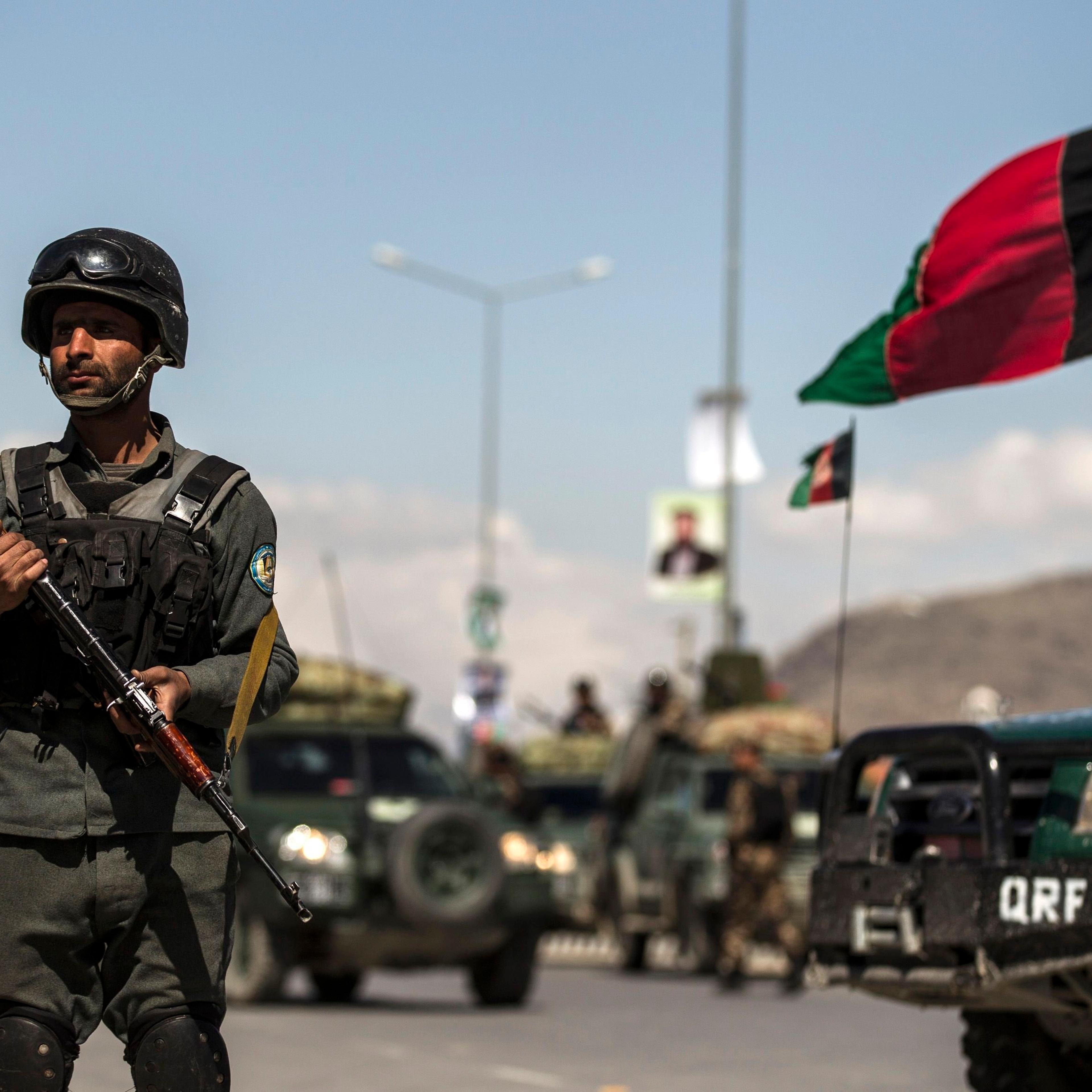 An Afghan policeman stands guard near the site of an attack in Kabul