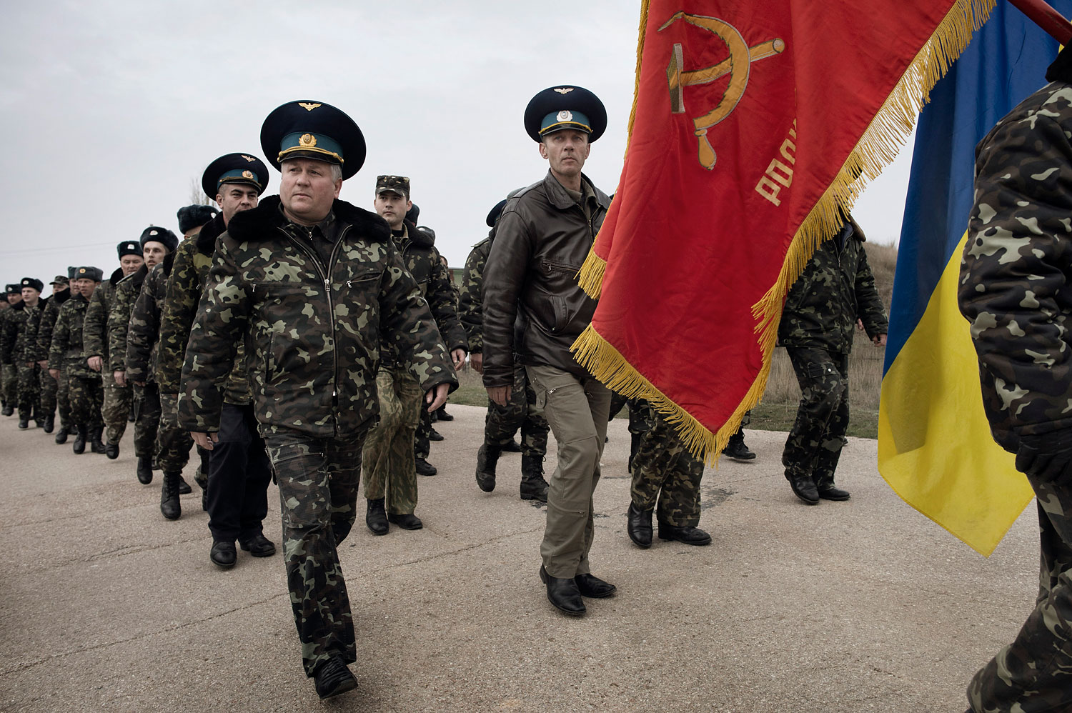 Unarmed Ukrainian soldiers approach Russian positions on the perimeter of the contested Belbek air force base in Crimea to press demands to return to their positions there and conduct joint patrols, March 4, 2014.