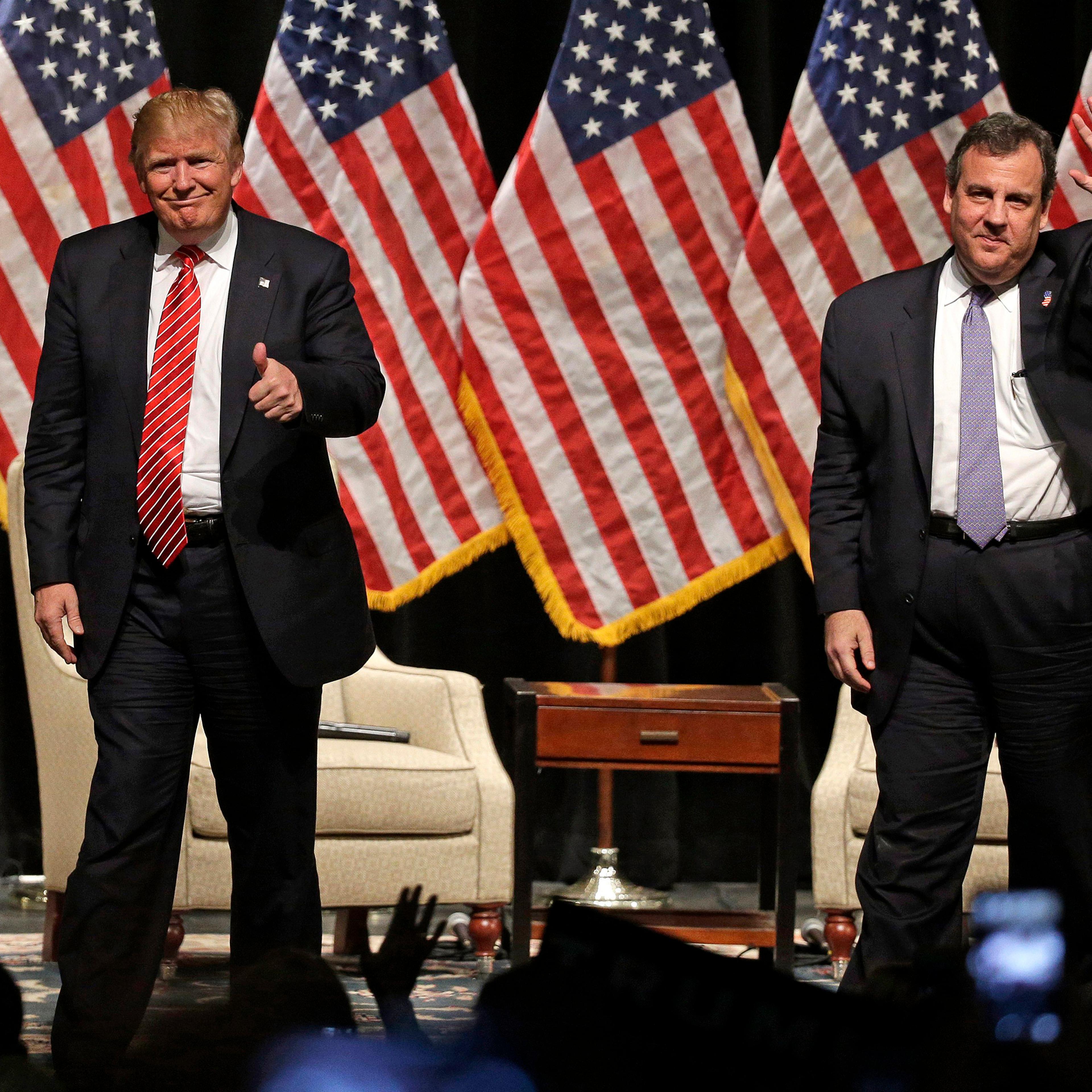 Donald Trump gives a thumbs up as New Jersey Gov. Chris Christie waves to the crowd as they walk off the stage after a rally at Lenoir-Rhyne University in Hickory, N.C., March 14, 2016.