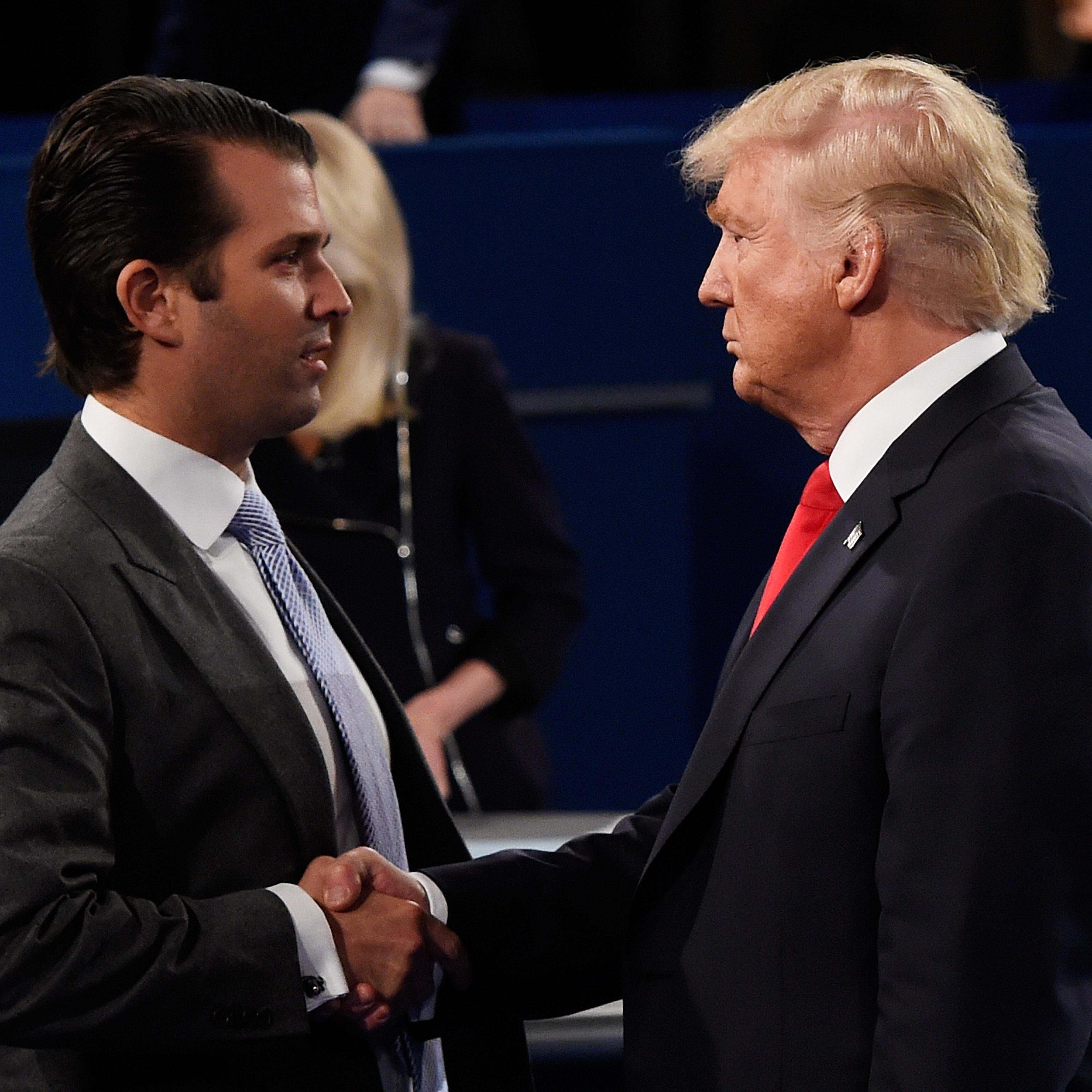 President Trump and Don Jr. shake hands