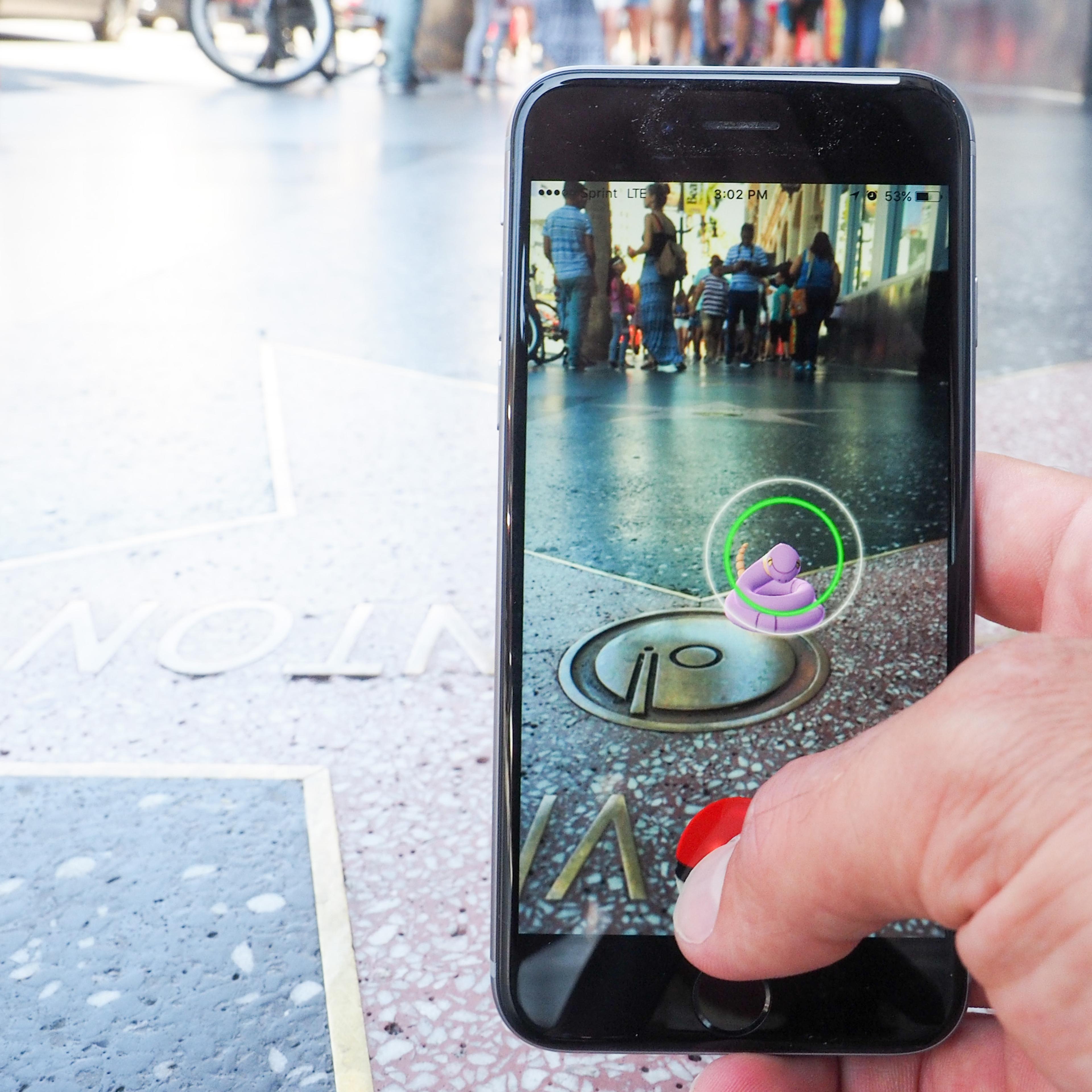 Pokemon Go players are seen on the Hollywood Blvd in search of Pokemon and other in game items on July 14, 2016 in Los Angeles, California.