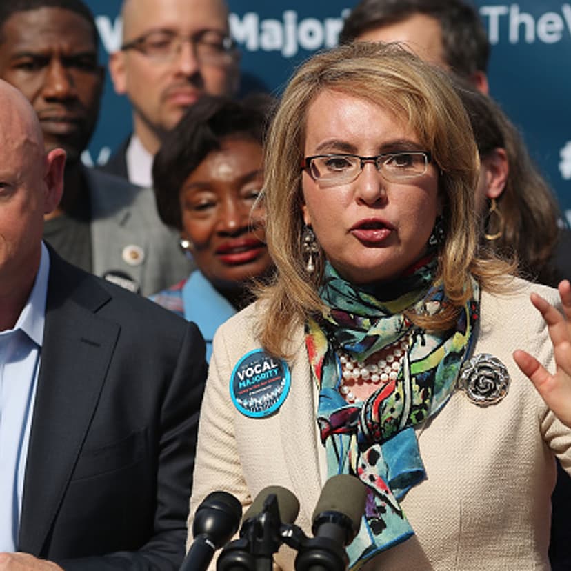 Gun violence victim and former U.S. Congresswoman Gabby Giffords speaks next to her husband, NASA astronaut Mark Kelly, as they visits City Hall on her 2016 Vocal Majority Tour on October 17, 2016 in New York City.