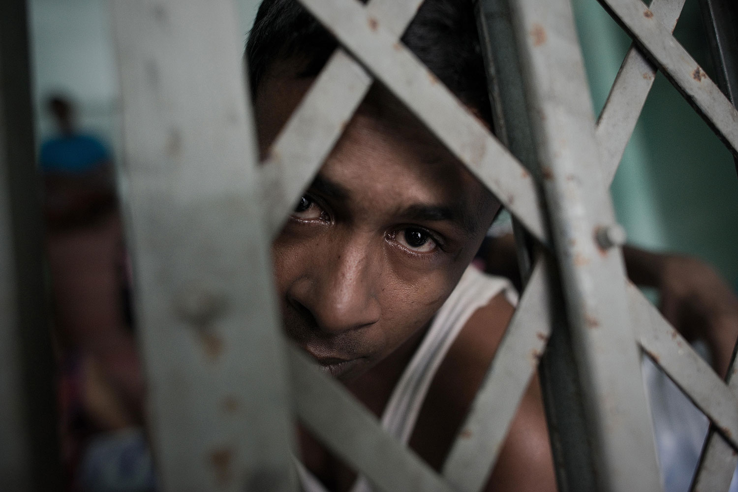 A Muslim Rohingha asylum seeker stands inside a cell at the Thai immigration detention centre in Phangnga, southern Thailand