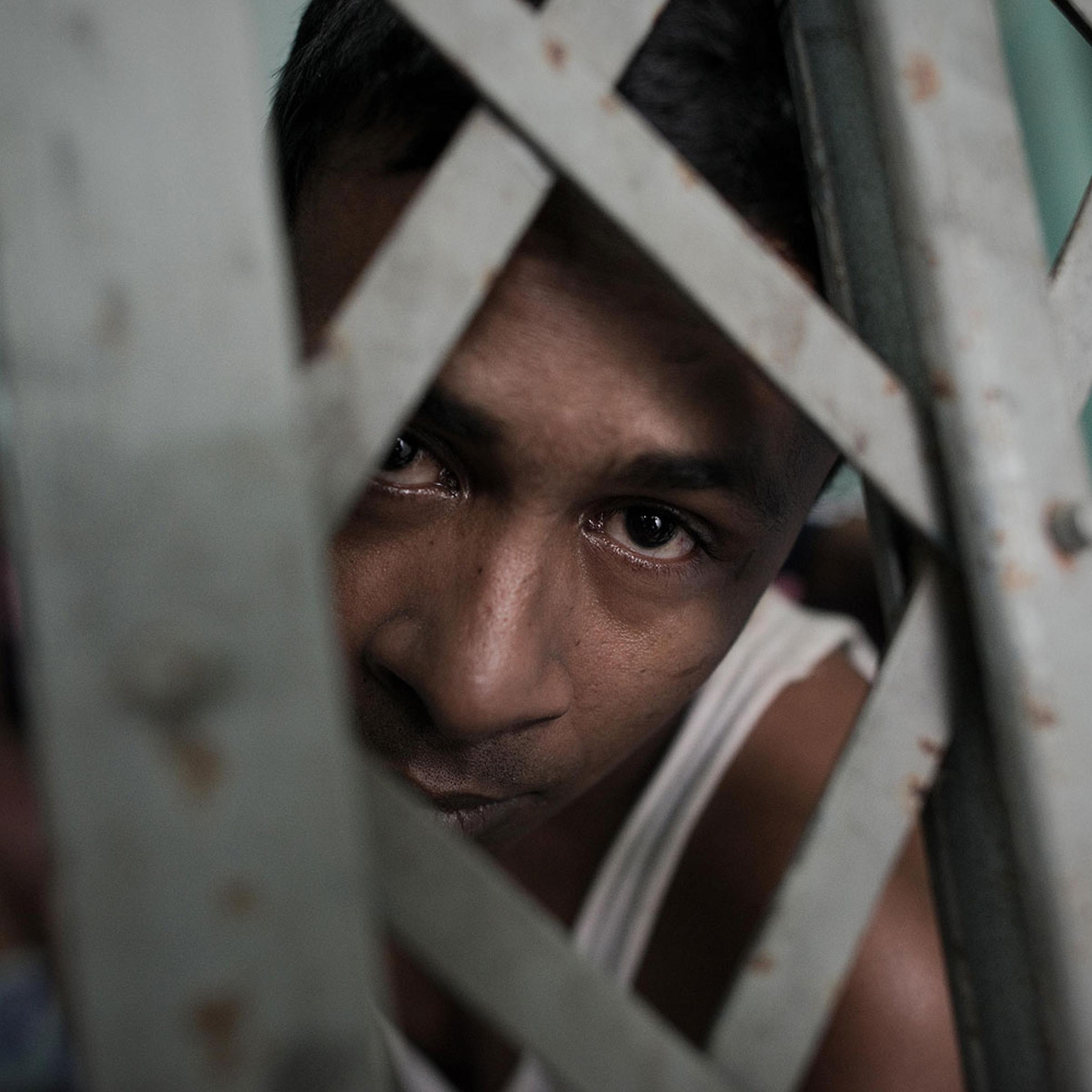 A Muslim Rohingha asylum seeker stands inside a cell at the Thai immigration detention centre in Phangnga, southern Thailand
