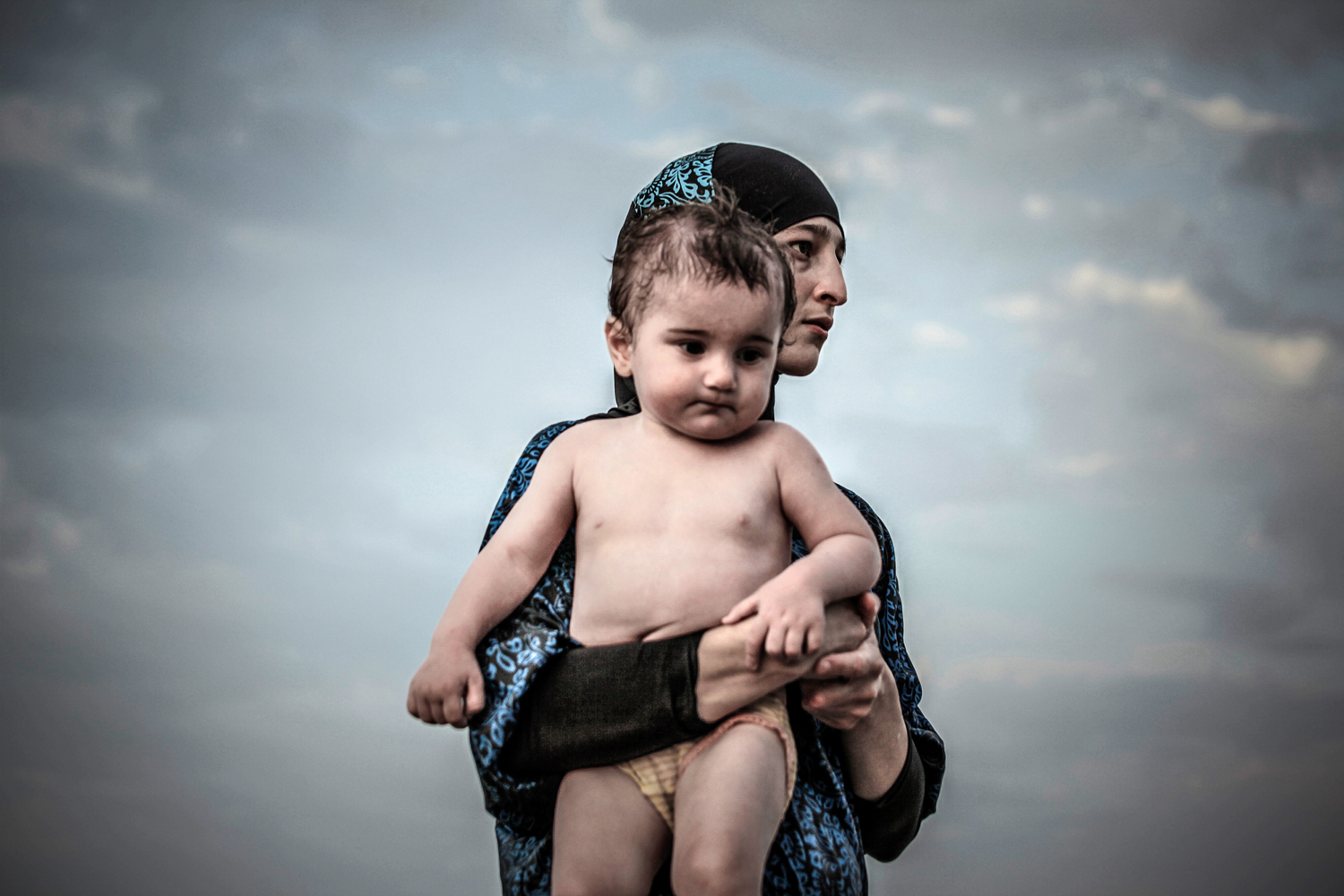 A Salafi woman with a child seen in a street of Kaspiysk.